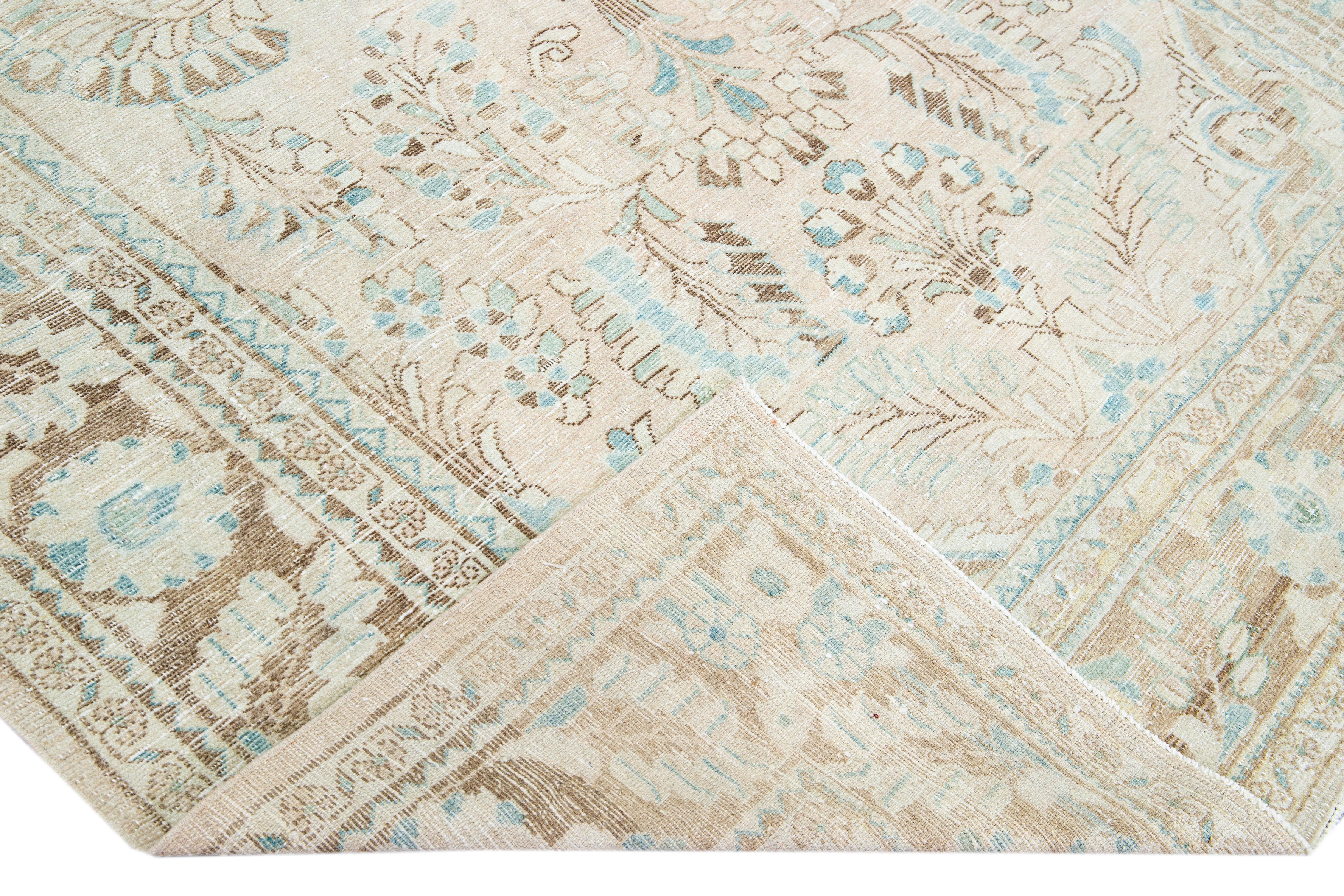 Beautiful hand-knotted antique Mahal wool rug with the Beige field. This Persian rug has a brown frame and blue accents featuring a traditional medallion floral pattern design. 

This rug measures 7'1