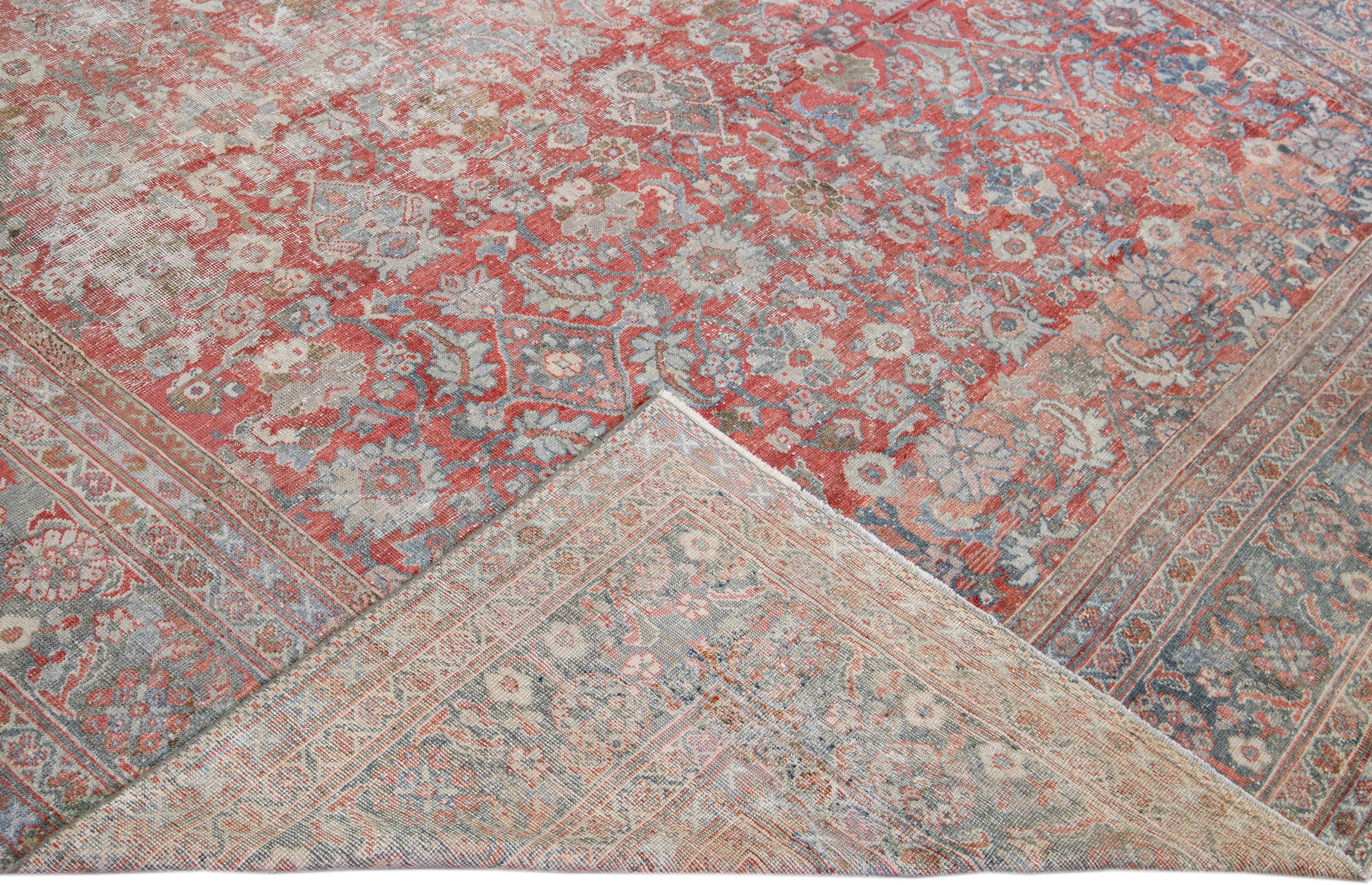 Beautiful hand-knotted antique oversize mahal wool rug with the red field. This Persian rug has a multicolor featuring a traditional all-over floral shabby chic design. 

This rug measures 10'6'' x 16'11