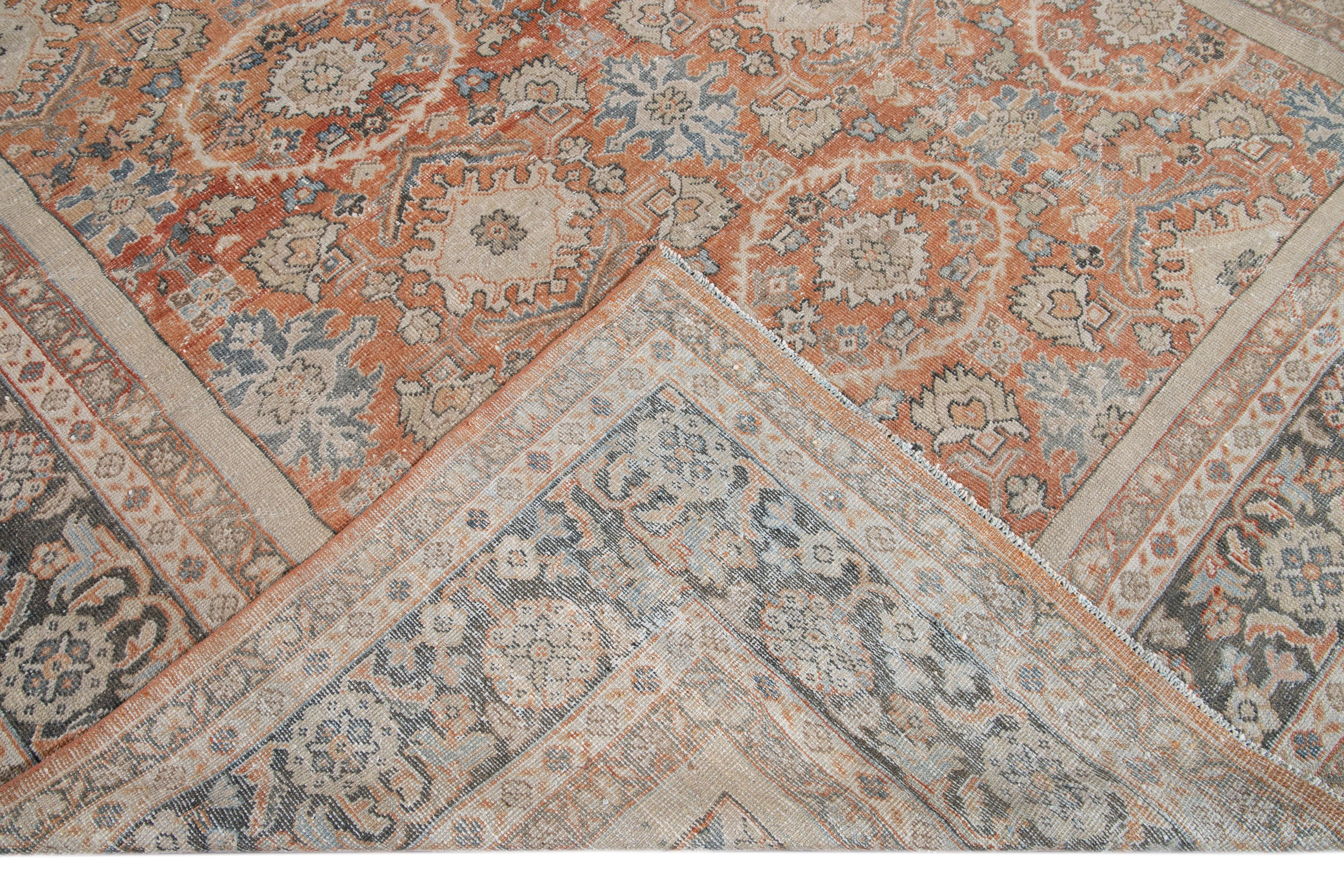 Beautiful antique Mahal hand knotted wool rug with a rust field. This rug has a blue frame and multi-color accents in a gorgeous all-over distressed shabby chic floral design.

This rug measures: 9'6