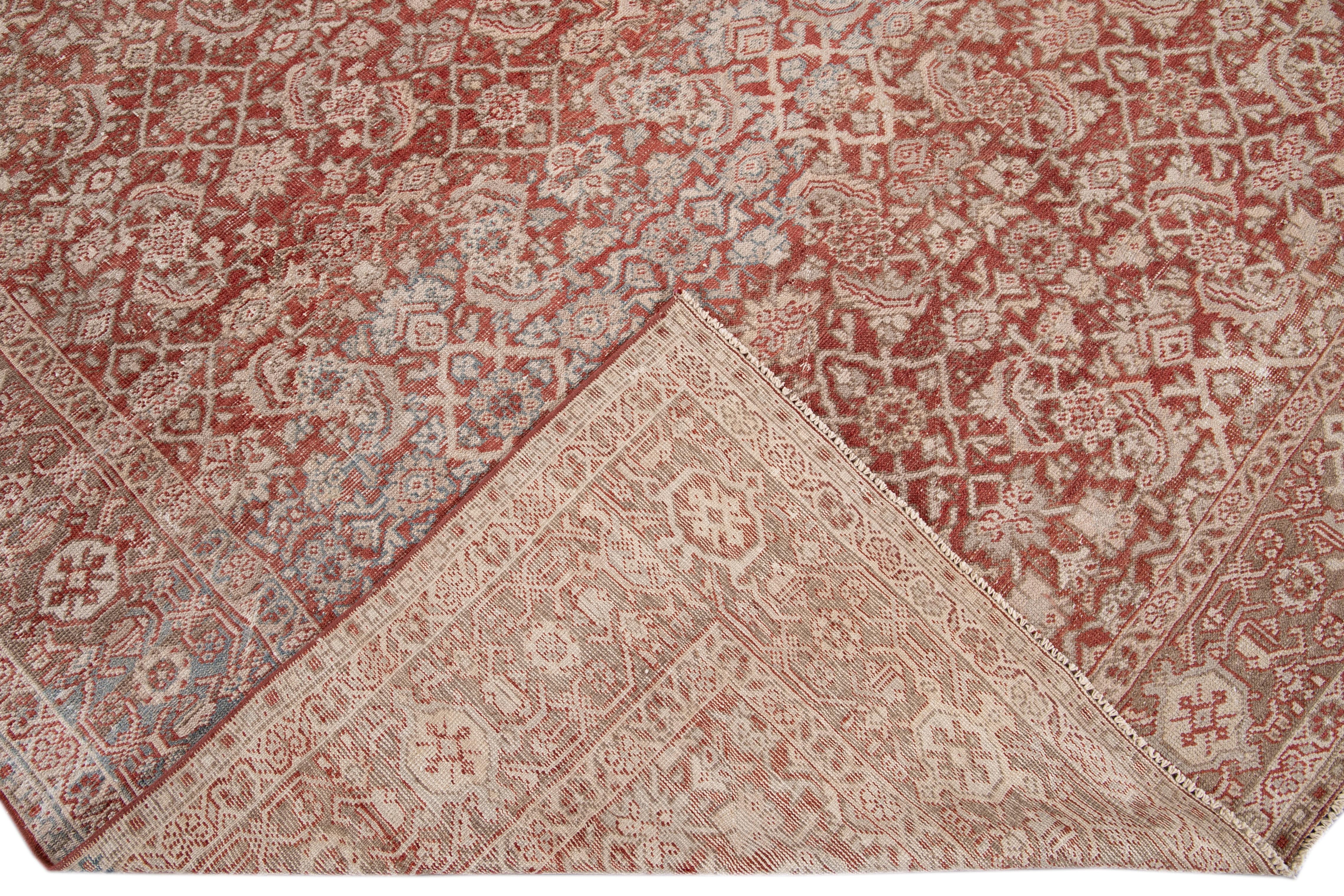 Beautiful antique Mahal hand knotted wool rug with a red field. This Mahal rug has a brown frame Ivory, brown, and blue accents in a gorgeous all-over geometric floral botanical design.

This rug measures 9'5