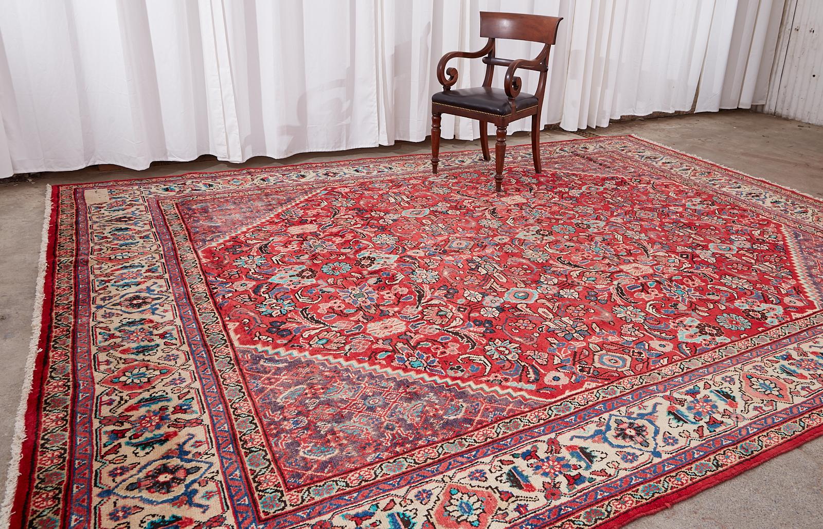 Fantastic traditional antique mahal rug featuring a field with triangular corners. The vivid colors stand out especially in the border over a beige ground. The entire rug is accented with bright teal colors that contrast the different shades of red.