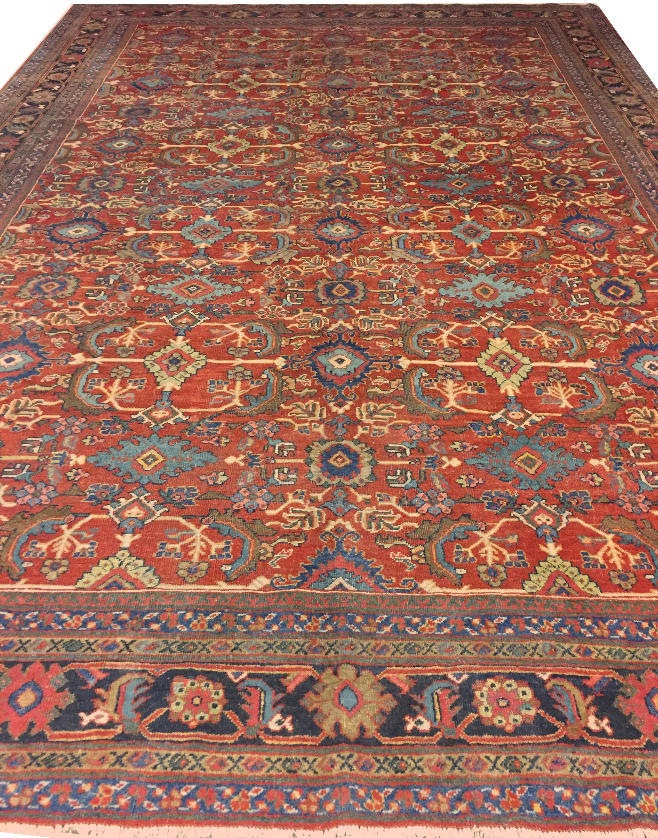 Antique Mahal Sultanabad carpet rug, 9'8 x 14'6. Symmetrical floral patterns climb up the brick red central field of this antique Mahal rug from Persia. Polychromatic floral and vine scroll patterns create a unified pattern along the center of the