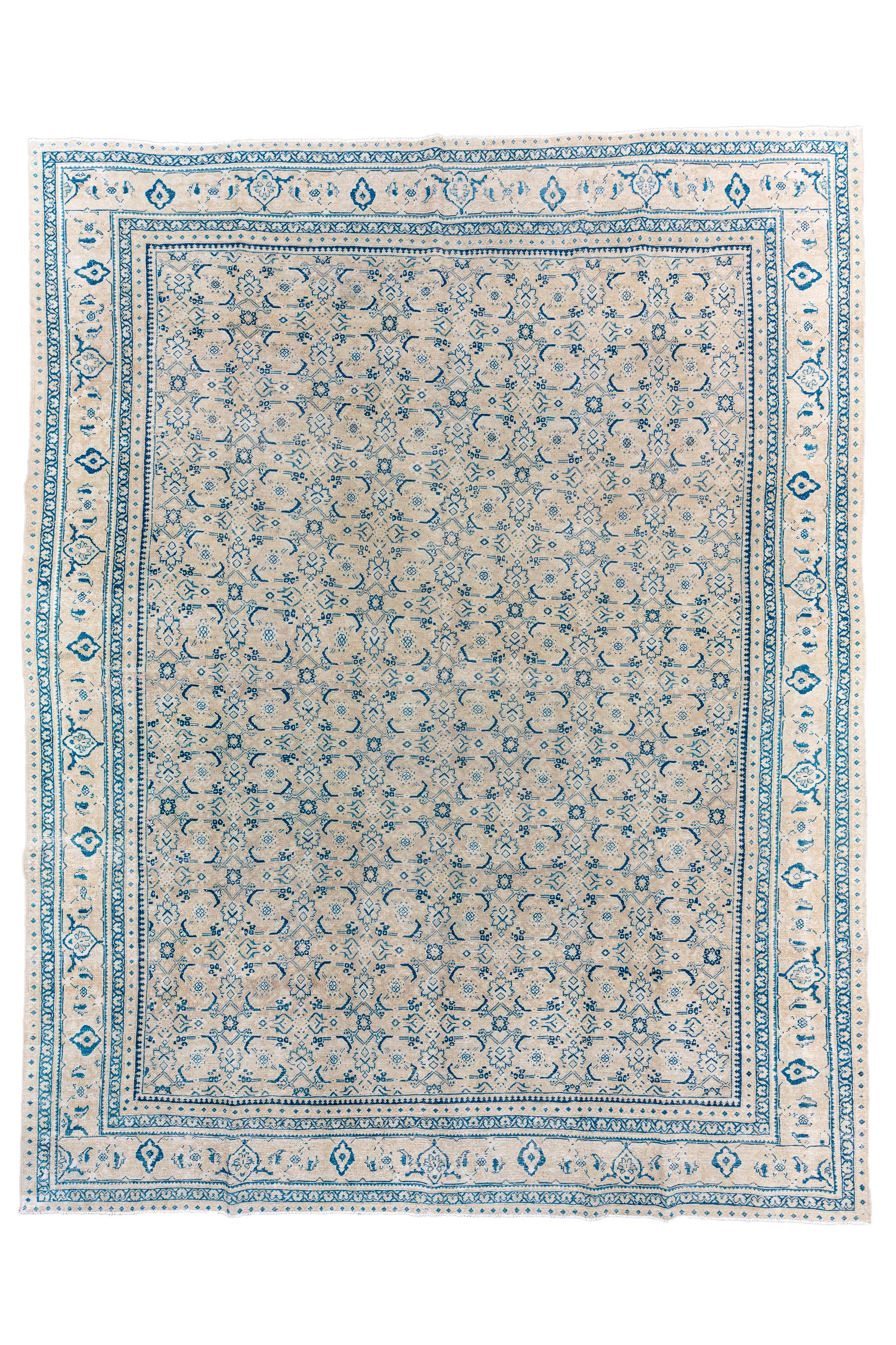 Mahal weavers just love the allover Herati design and here it is rendered in particularly small scale on  a light ground, with prominent paired sickle leaves . The straw strip style border shows simple turtle palmettes. The pattern is particularly