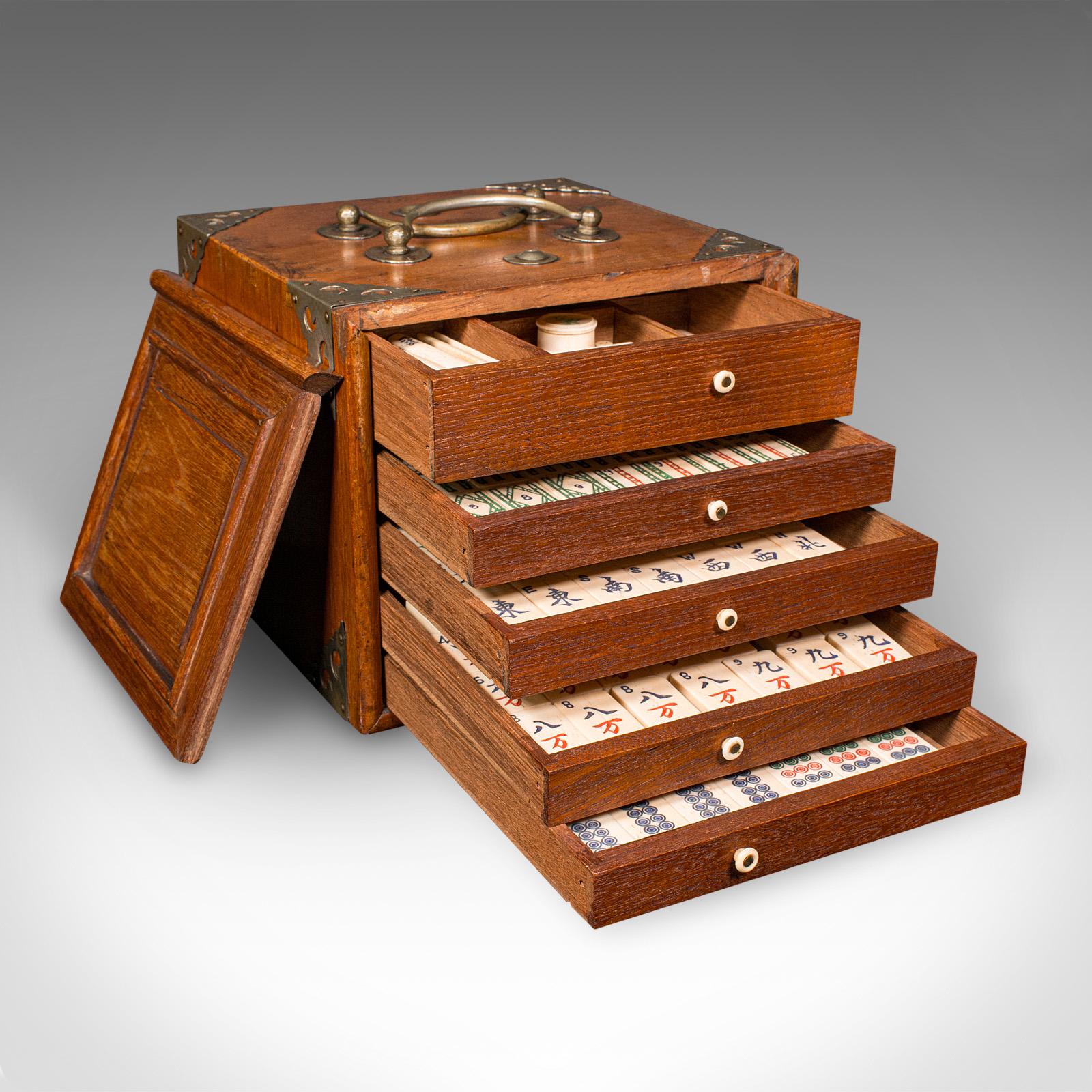 This is a superb antique Mahjong case. An Oriental, teak gaming tile box, dating to the late Victorian period, circa 1900. Showcasing fine craftsmanship and a complete selection of components, this elegant set makes for a delightful collector’s