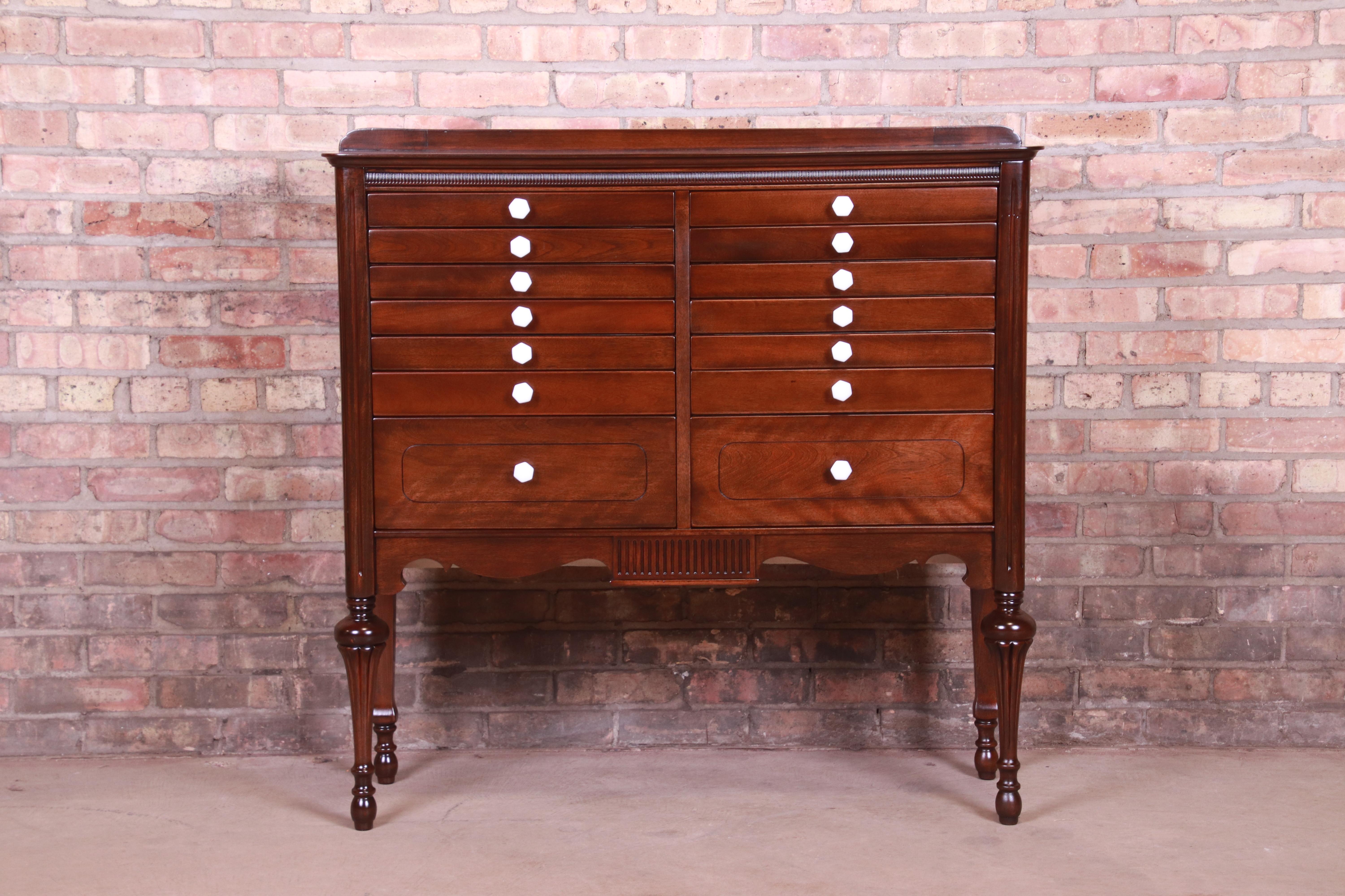 A rare and unique 14-drawer dental cabinet

USA, circa 1920s

Carved mahogany, with porcelain drawer pulls and metal drawer interiors.

Measures: 40.75