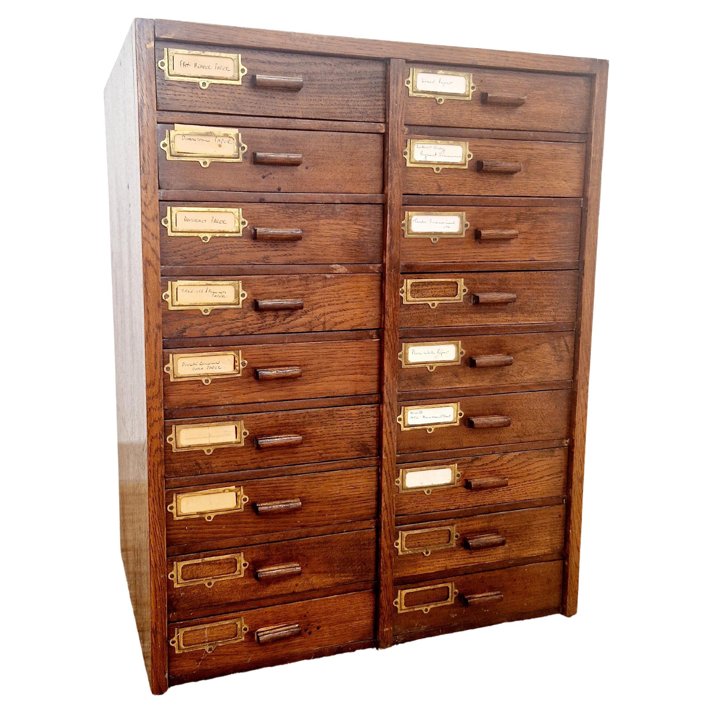 This Antique Oak 18 Drawer Index Cabinet is a stunning piece of Victorian style furniture made in the early 1900s in the United Kingdom. With its original craftsmanship and unique design, this cabinet is a timeless treasure that adds a touch of