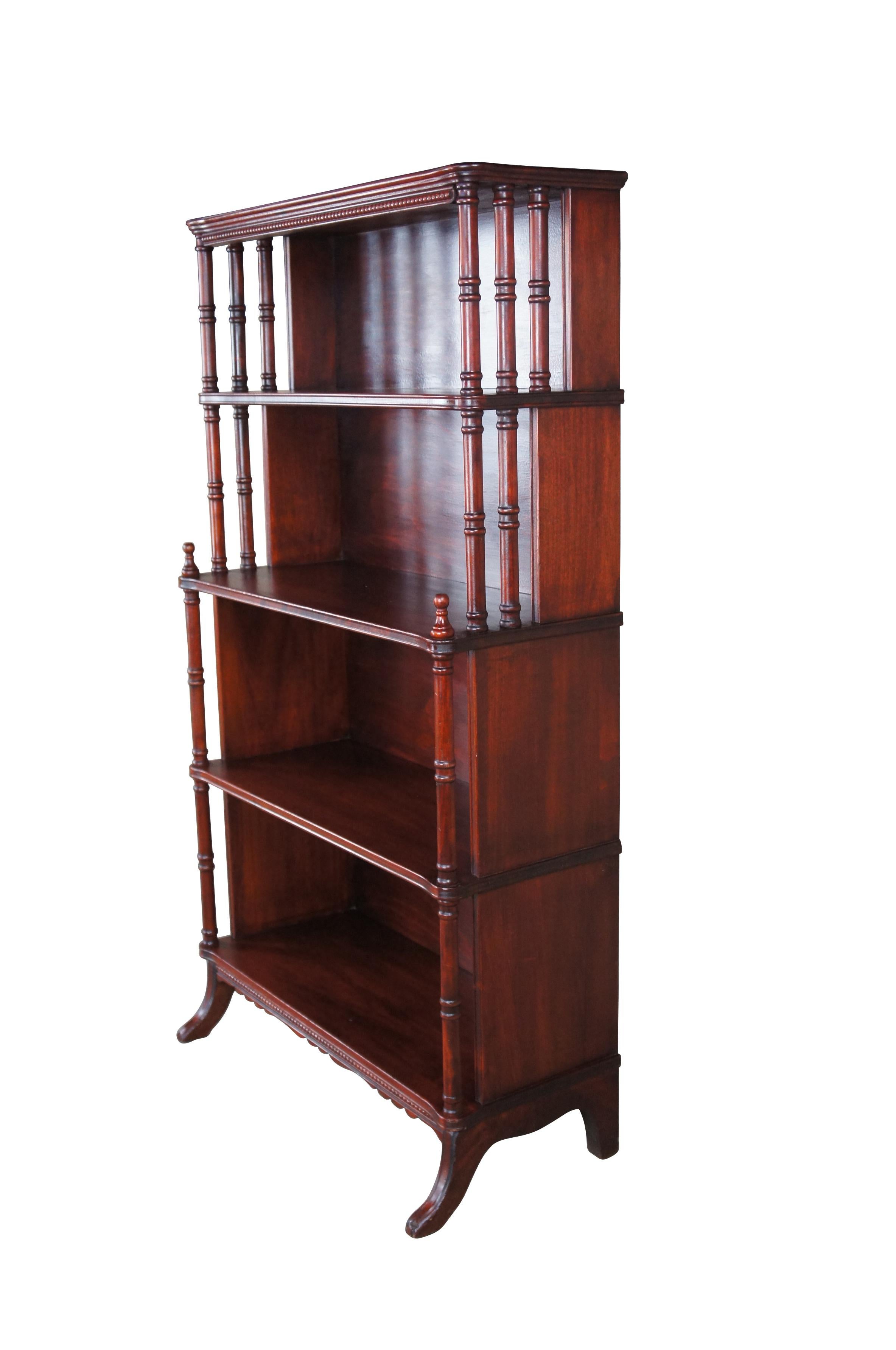 Antique mahogany four shelf book case or display stand featuring a step back design with turned posts and Duncan Phyfe legs.  Circa 1940.

Dimensions:
28
