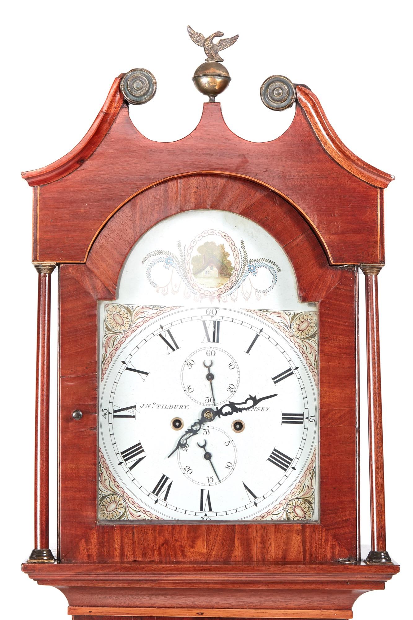 Antique mahogany 8 day longcase clock J N Tilbury Guernsey with a swan-neck pediment original brass finial, lovely decorative and colorful arched painted dial with date and seconds dial, 8 day duration mechanism striking the hour on a bell, lovely