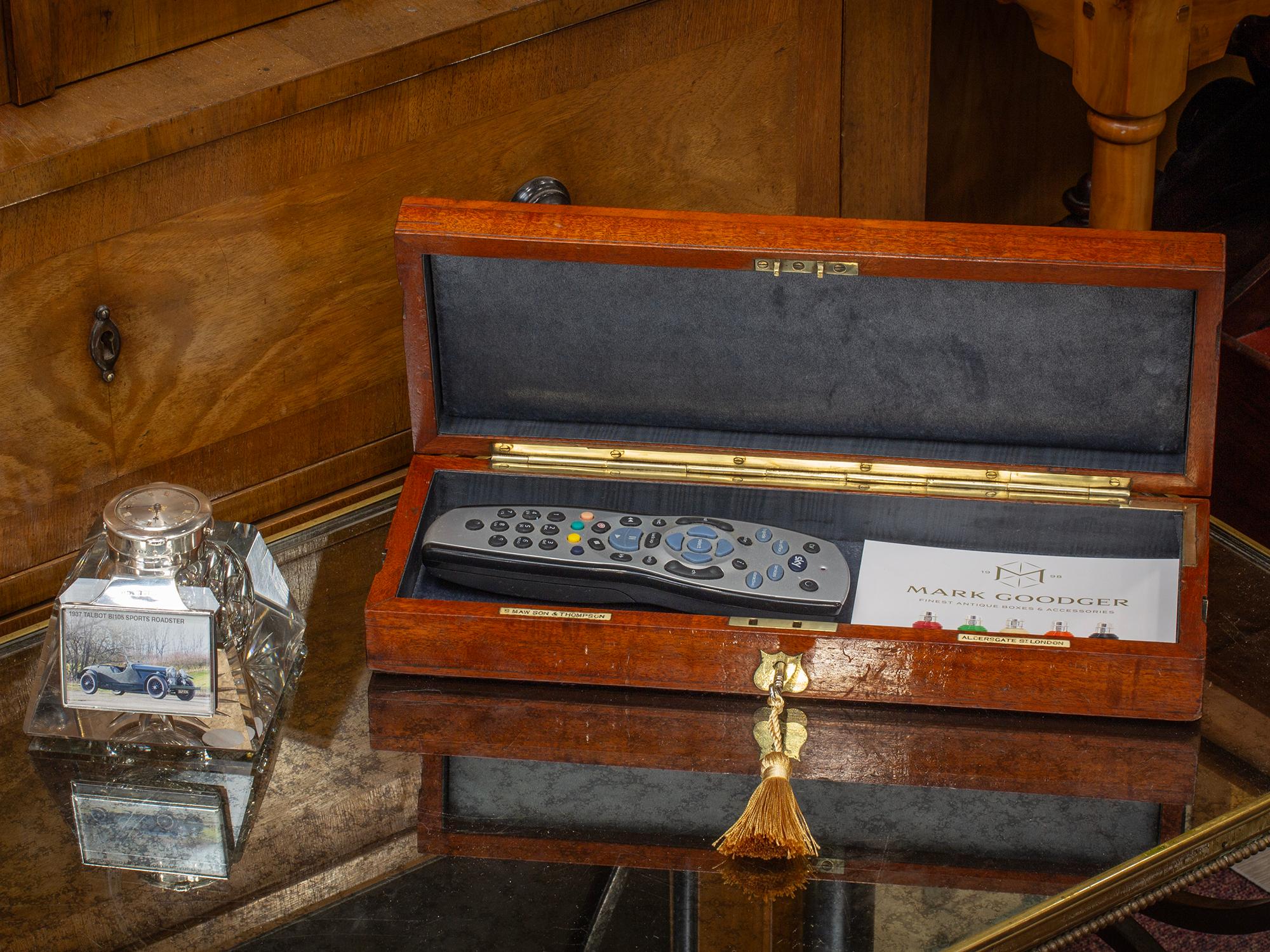 Fully Lined Interior

From our Jewellery Box collection, we are pleased to offer this Antique Mahogany Accessories Box. The Box of rectangular elongated form made from solid Mahogany with brass screws decorating the lid framing a central shield