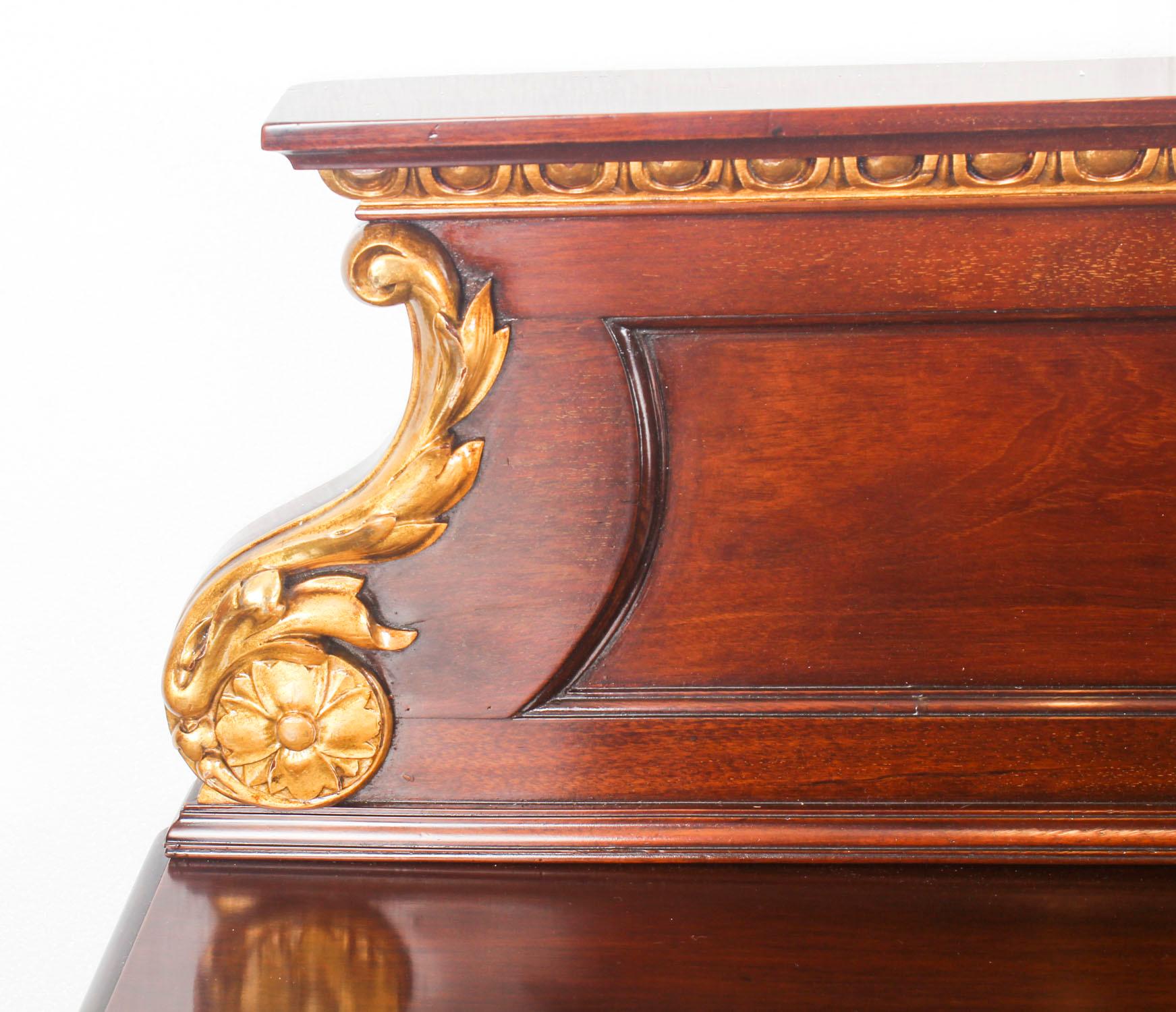 This is a fine monumental antique mahogany and parcel gilt serving table in the George II manner and dating from the mid-19th century.

The back is decorated with egg and dart moulding and acanthus scrolls. The central bow front drawer is flanked by
