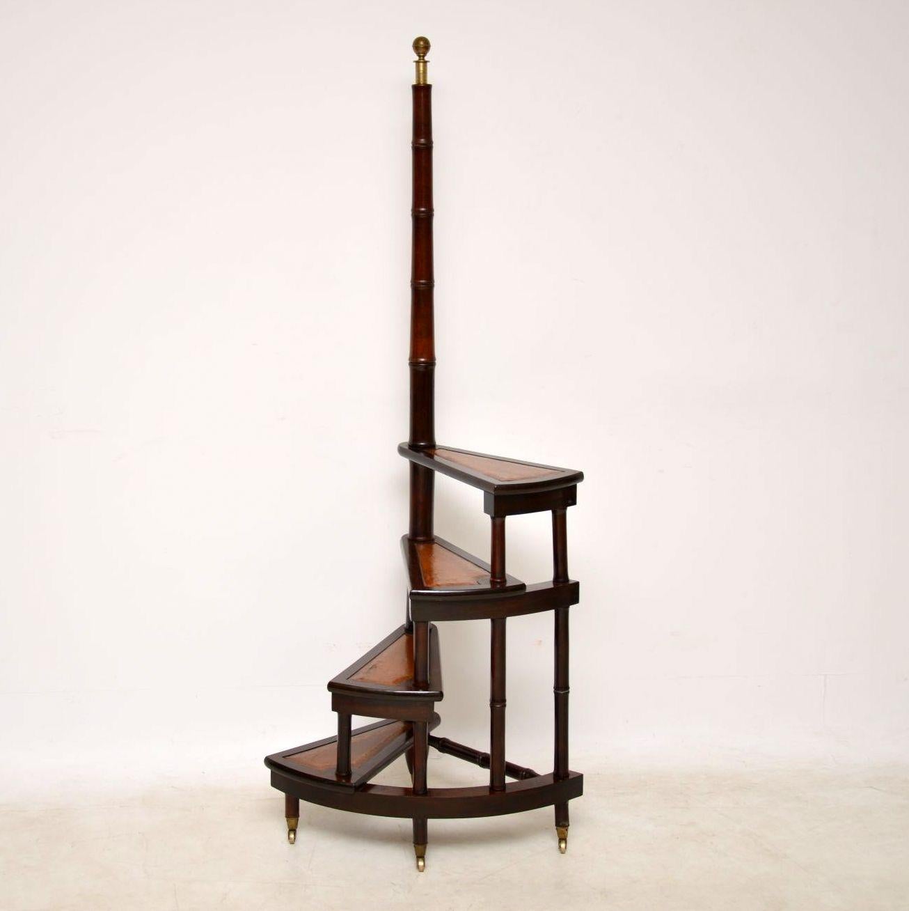Antique spiral library steps in mahogany with tooled leather insets on all the steps. These steps are very well constructed, a decent size and quite useable. The top upright is well turned and has a brass finial on the top. The base is strengthened