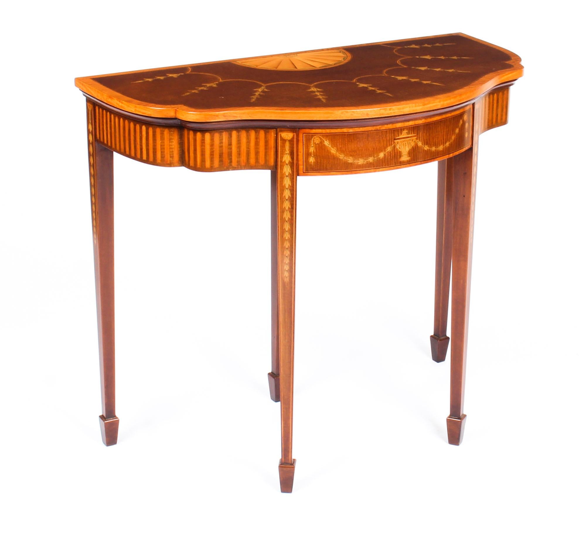 This is a stunning antique George III revival serpentine card table, circa 1880 in date.

This splendid card table features a fold over top with beautiful inlaid marquetry decoration of columns of bluebells and a delightful half-moon starburst.
