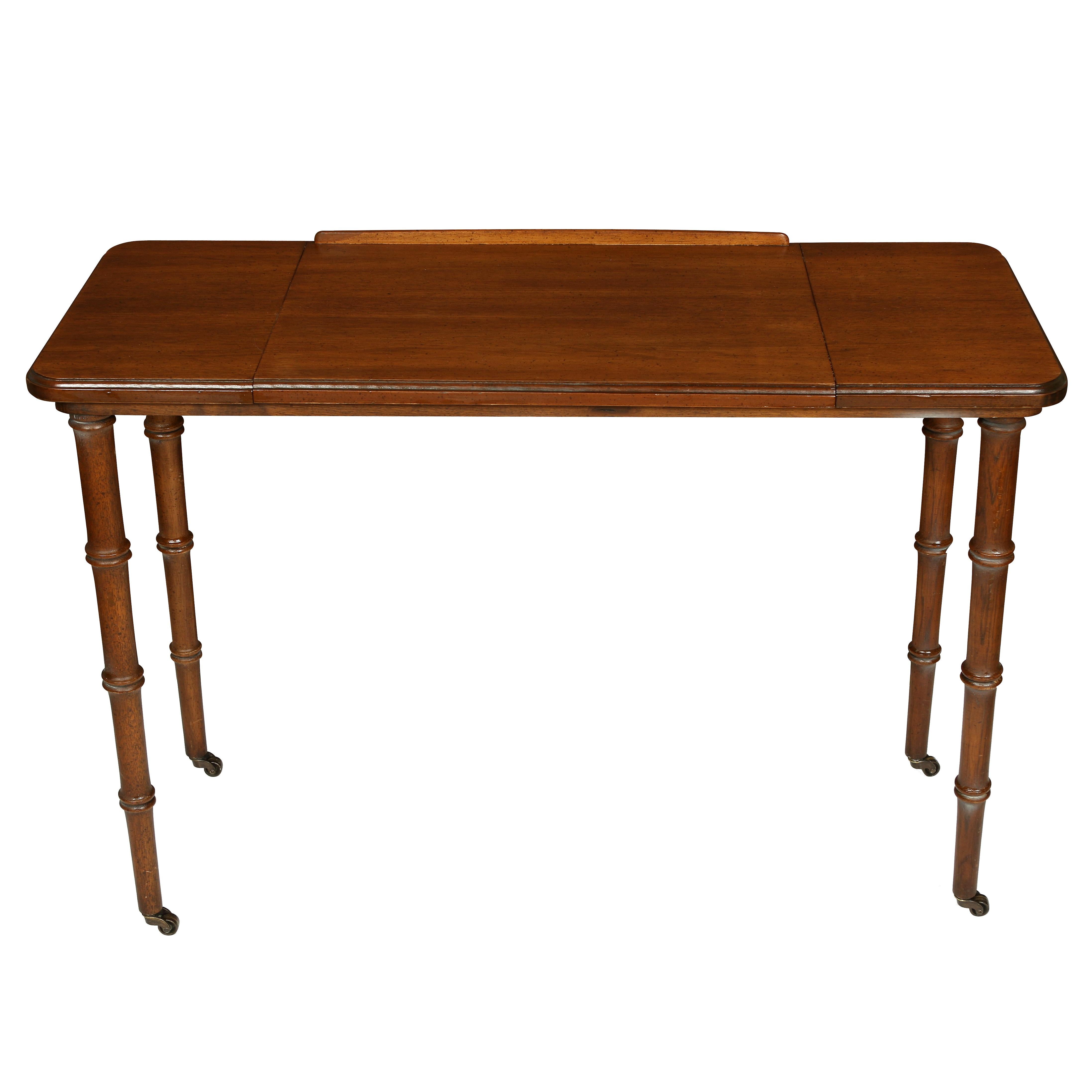 Antique mahogany architect's table with bamboo shaped legs and caster wheels.