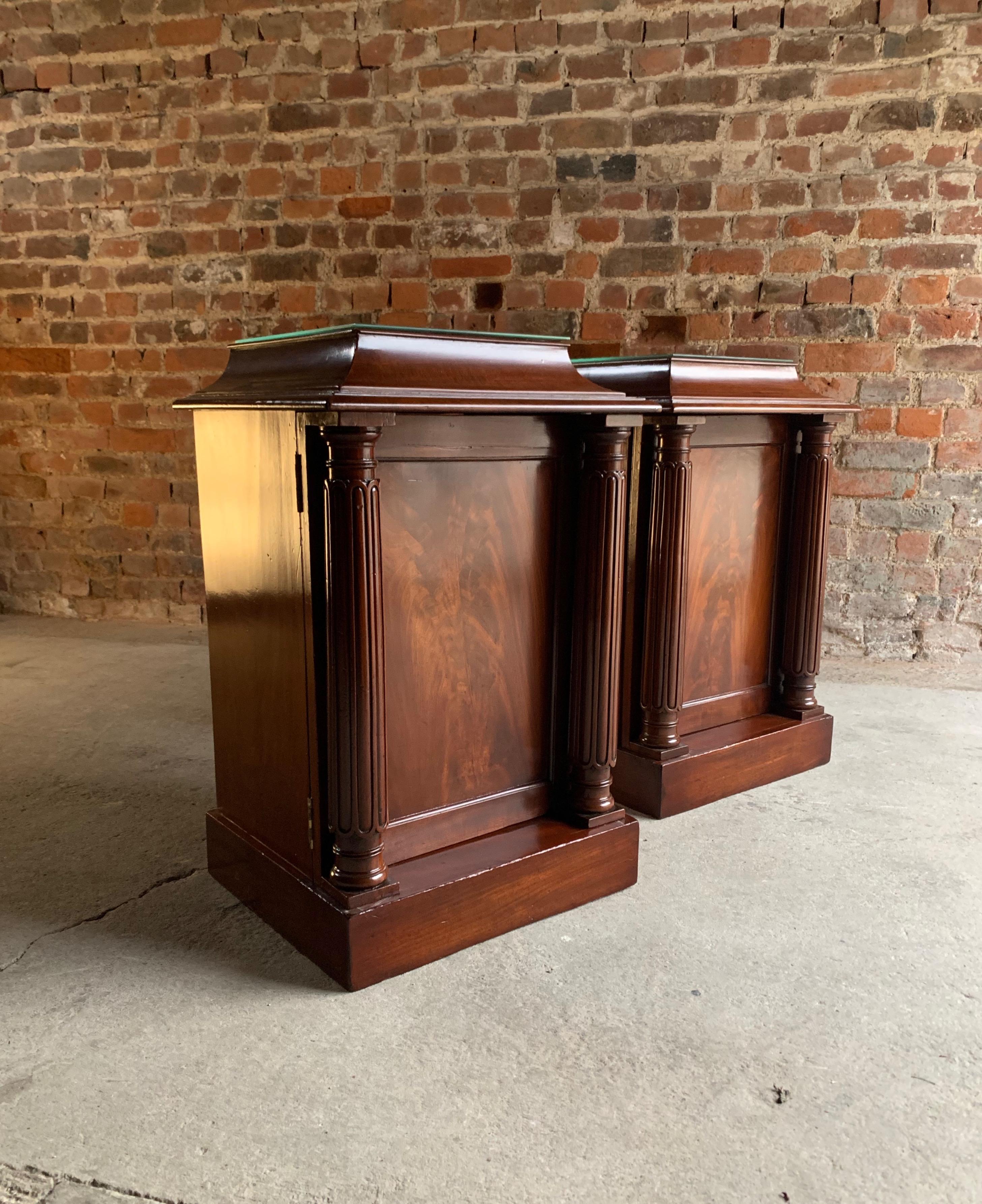 A stunning and very grand pair of antique mid-19th century flame fronted mahogany bedside cabinets Victorian circa 1850, the rectangular tops each with beveled glass over left and right opening flamed mahogany doors, one with a single shelf and the