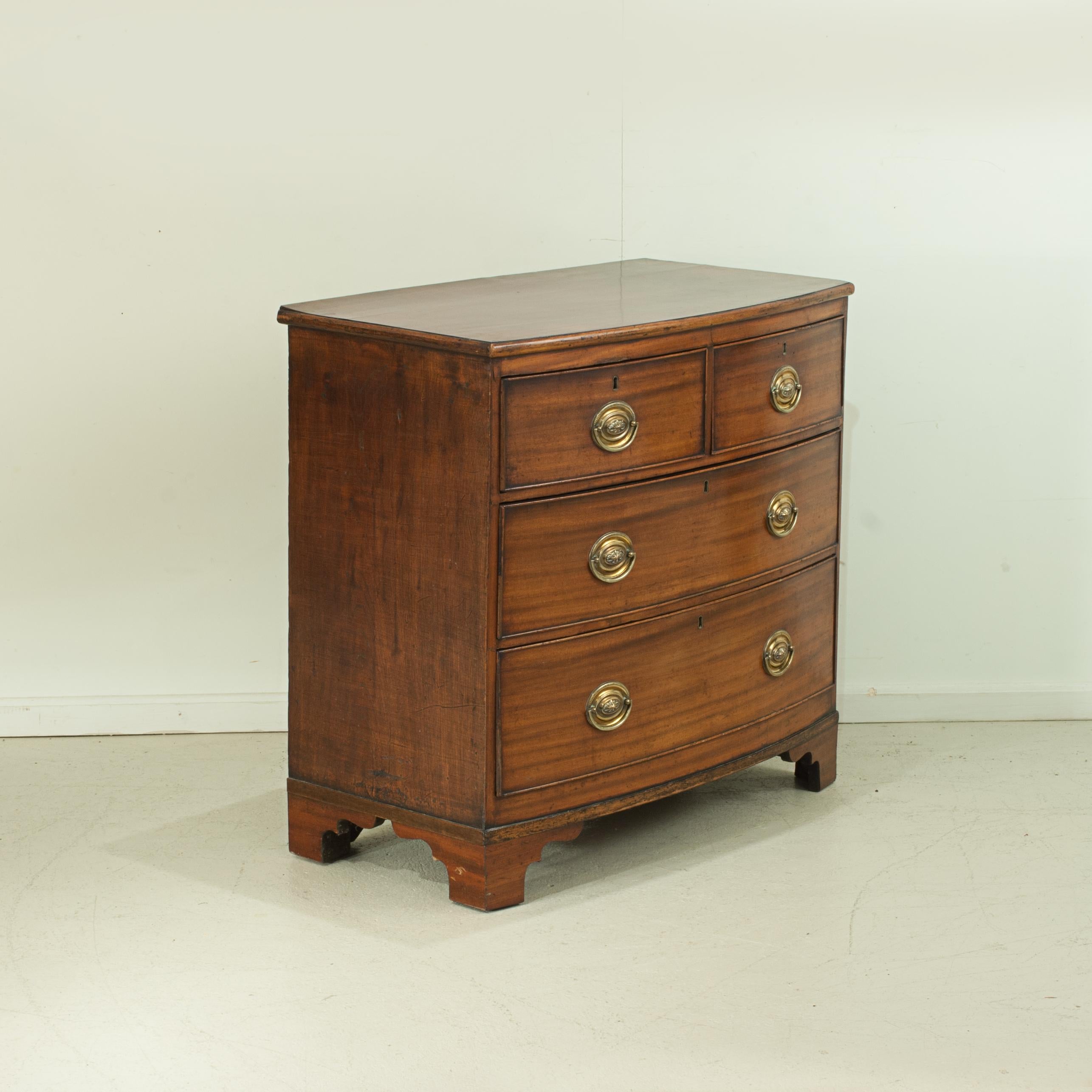 Small bow-front chest of drawers.
A rather charming, small, Regency mahogany bow fronted chest of drawers. Two short drawers over two more long graduated drawers, all fitted with brass oval back plate handles. This useful chest is raised on later