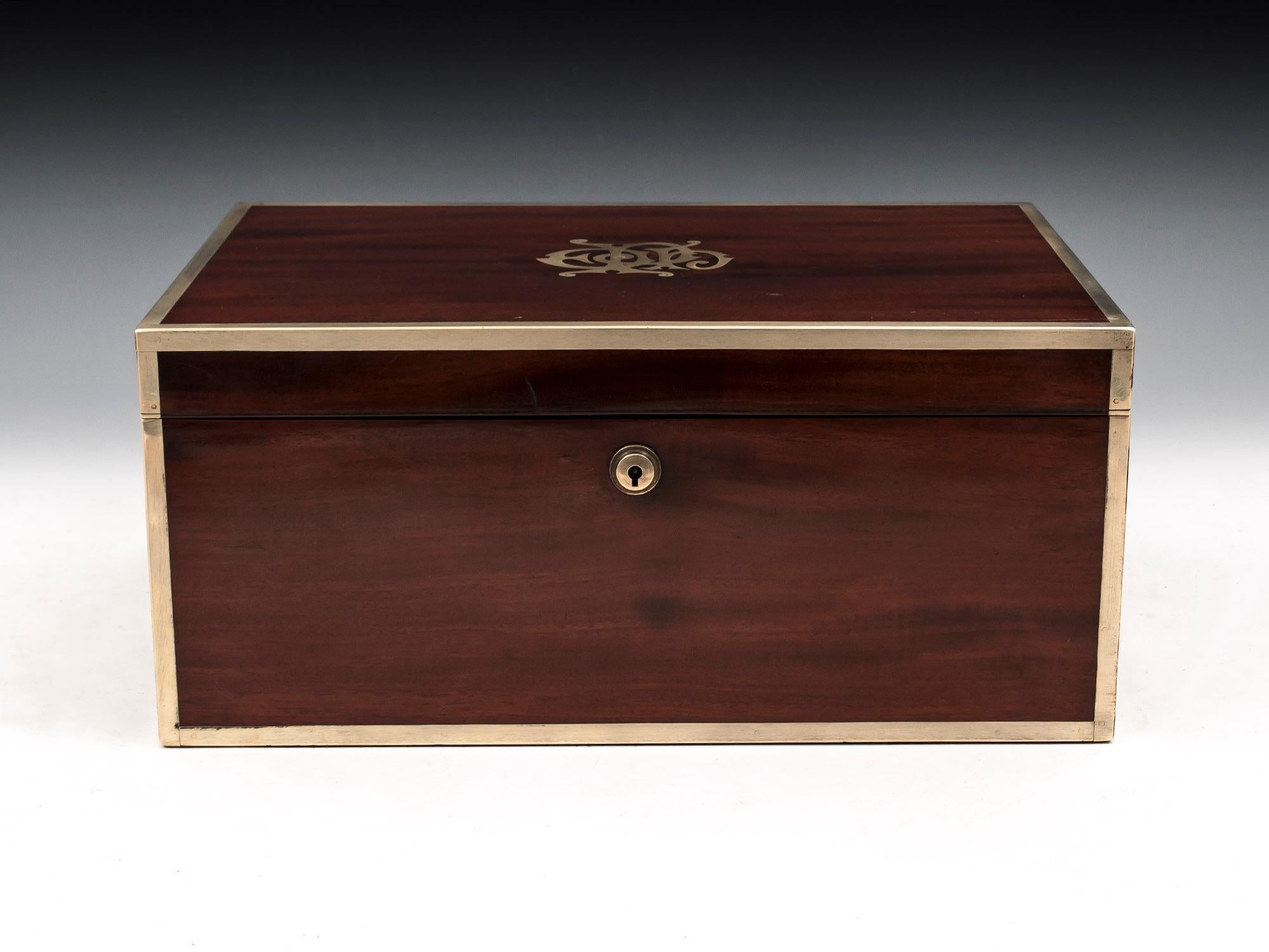 Antique Military Box in solid mahogany with bold brass edging, campaign flush fitting cary handles and large monogram which reads EPH 

The military box interior is lined with a luxurious royal blue velvet. The underside of the lid has its original