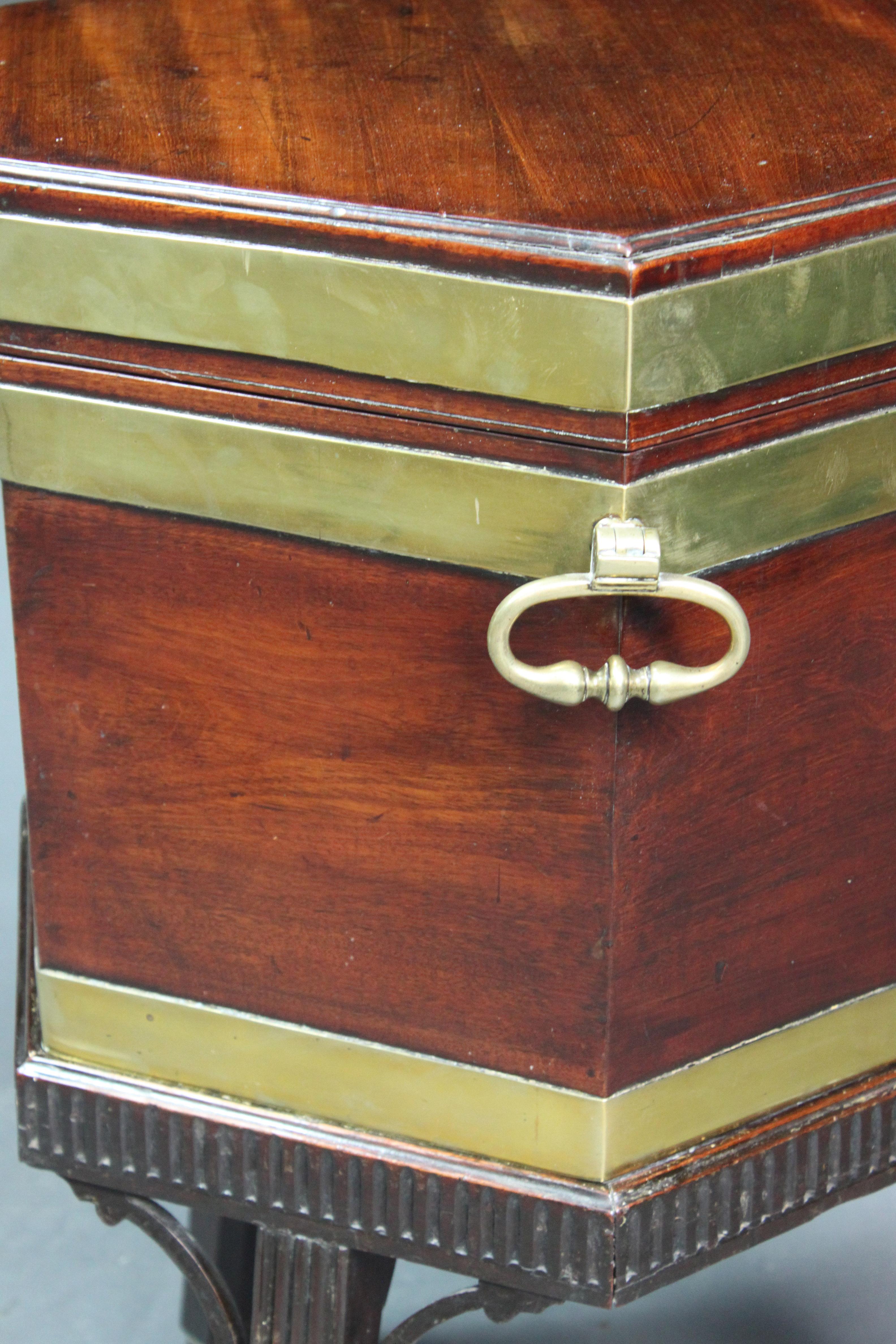 A fine George III Chippendale period mahogany brass bound wine cooler on its original stand with a fluted frieze, moulded reeded legs and open brackets.