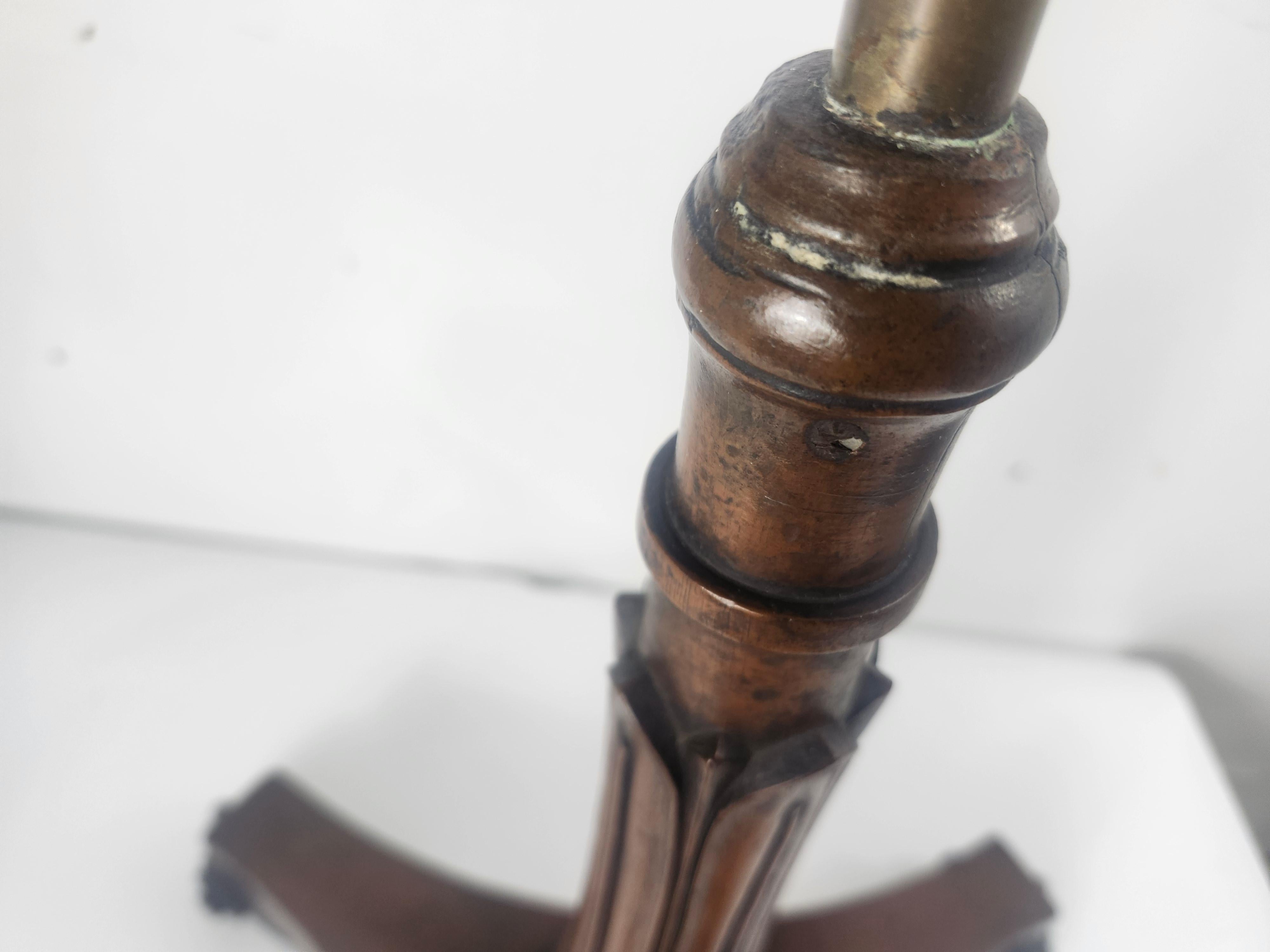 Fabulous mahogany double sided adjustable music stand. Carved violin neck scroll base with a lyre top that oufits two musicians.  Brass pole that is adjustable allowing the height of your choice. In excellent antique condition with minimal wear from