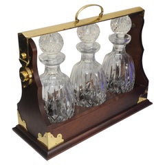Antique Mahogany & Brass Tantalus With A Set of Three Cut Glass Decanters