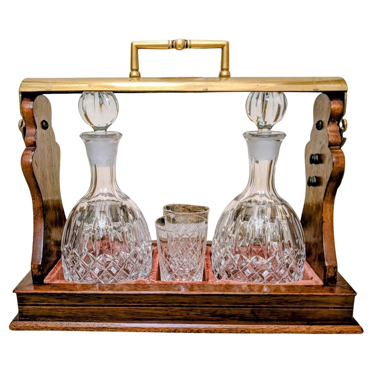 Antique Mahogany 
Brass Tantalus With Cut Glass Decanters And Glasses For Sale