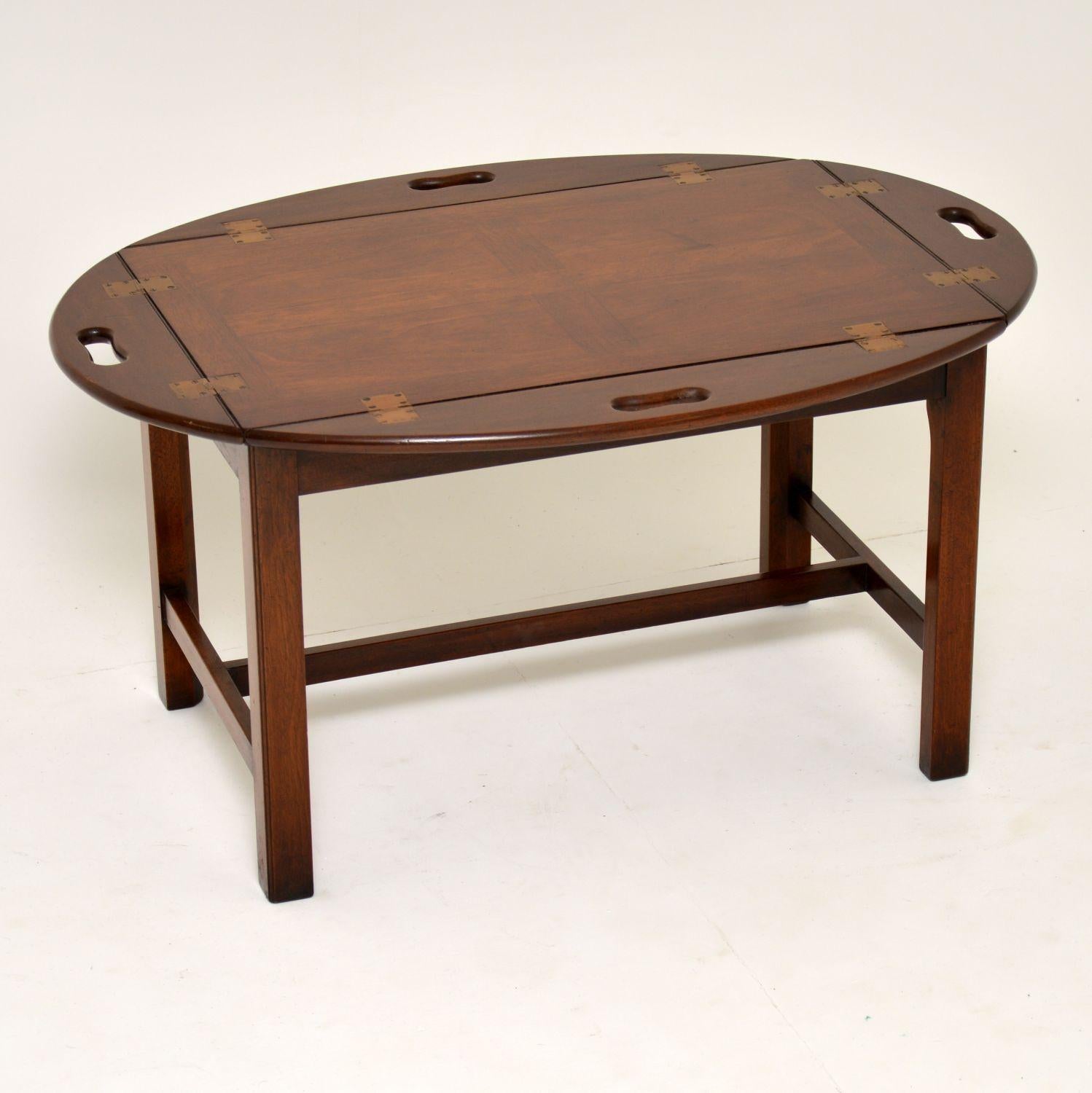 This antique mahogany Georgian style butlers tray coffee table is a great looking item and very practicable too. It’s in excellent condition and dates from circa 1950s period. The table top is panelled with four hinged flaps which have inset