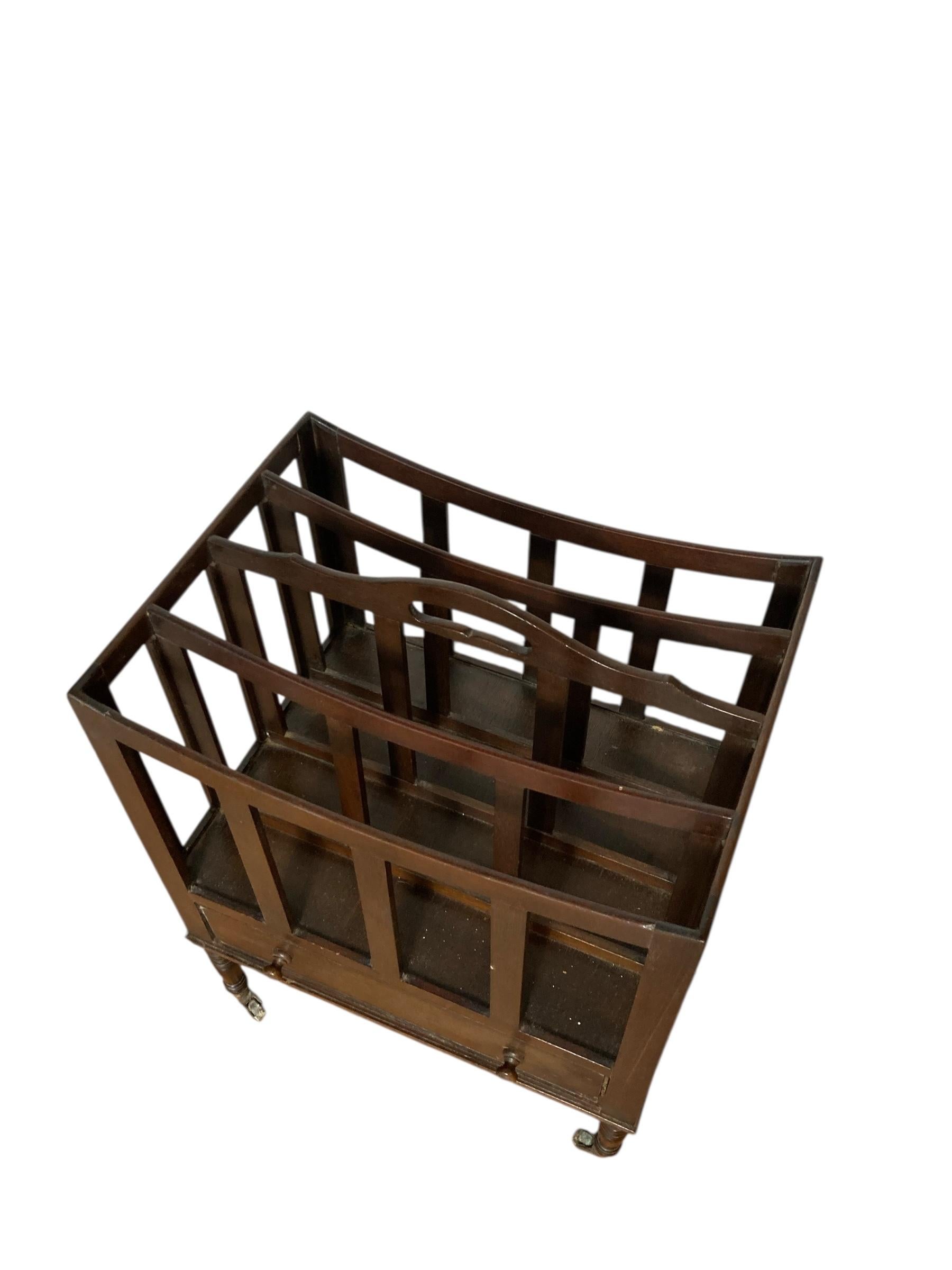 Antique Mahogany Canterbury Magazine or Paper Rack single drawer on original casters with carry handle.

H: 53cm

W: 40cm

D: 30cm