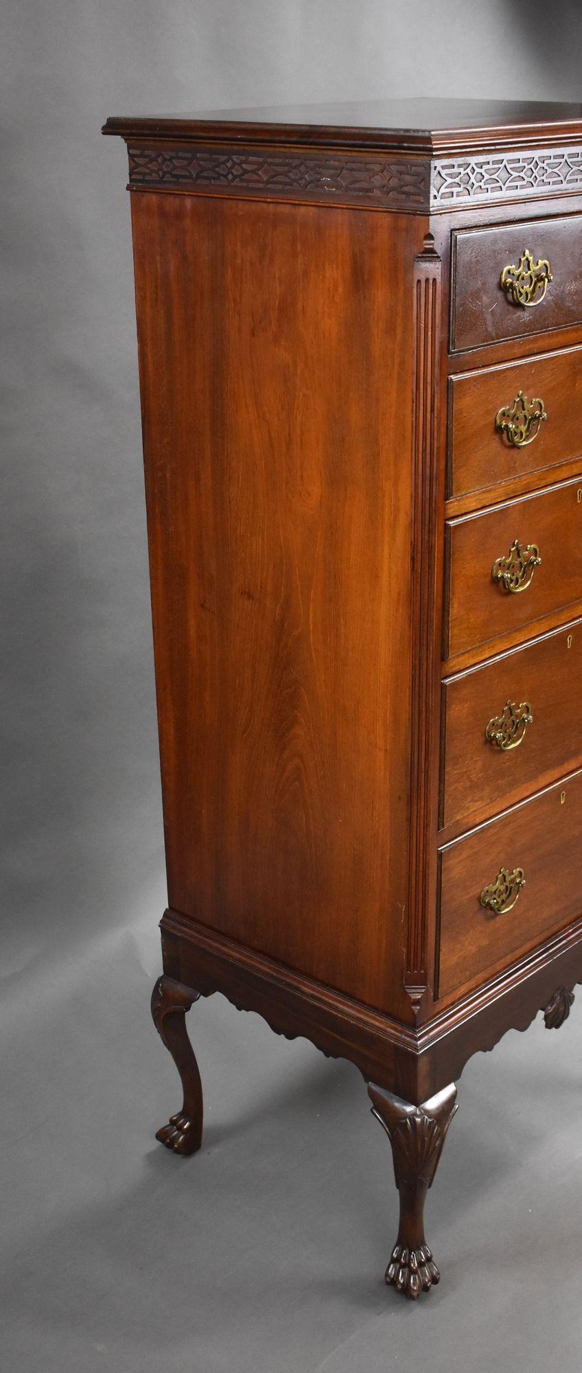 For sale is a good quality antique mahogany chest on stand, having a blind fretwork frieze above an arrangement of five drawers, each with brass handles. The chest base stands on elegant cabriole legs terminating on intricately carved paw feet. This