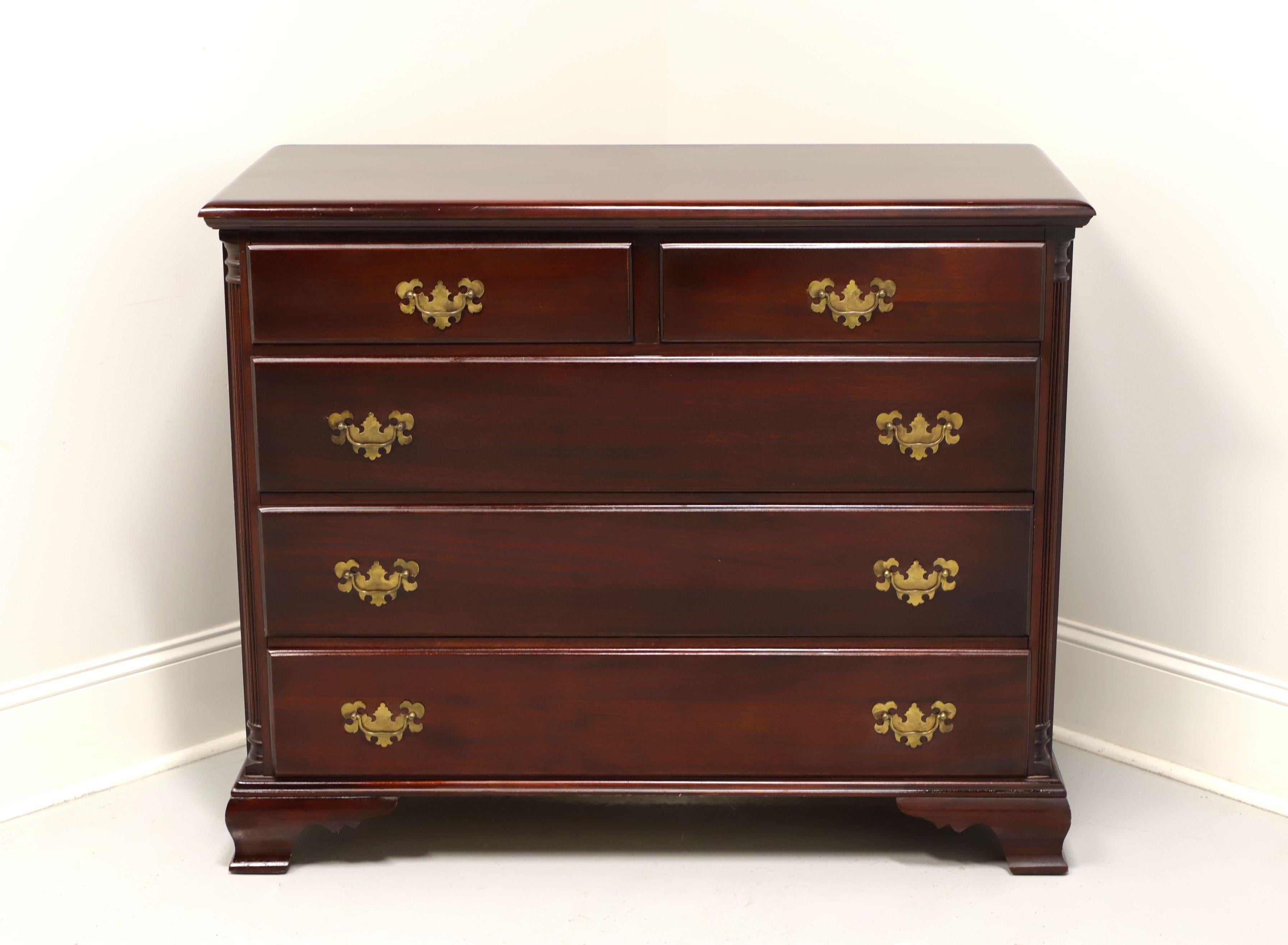 An antique bachelor chest in the Chippendale style, unbranded. Solid mahogany with brass hardware, fluted column sides and ogee bracket feet. Features two smaller over three larger drawers of dovetail construction. Made in the USA, in the early 20th