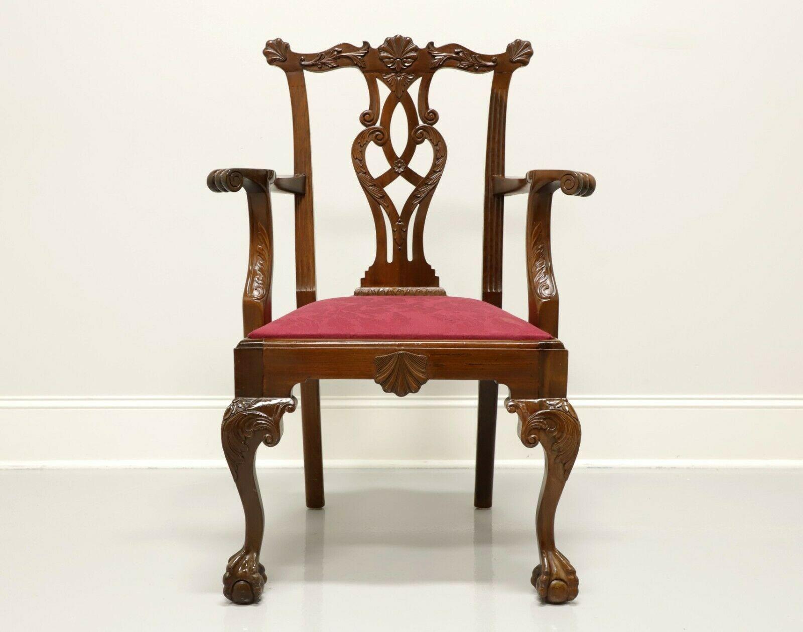 An antique Chippendale style armchair, unbranded. Solid mahogany with carved crest rail, back splat, arms, knees, ball in claw feet and crimson red brocade fabric upholstered seat. Possibly made in the USA, in the late 19th Century.

Measures: