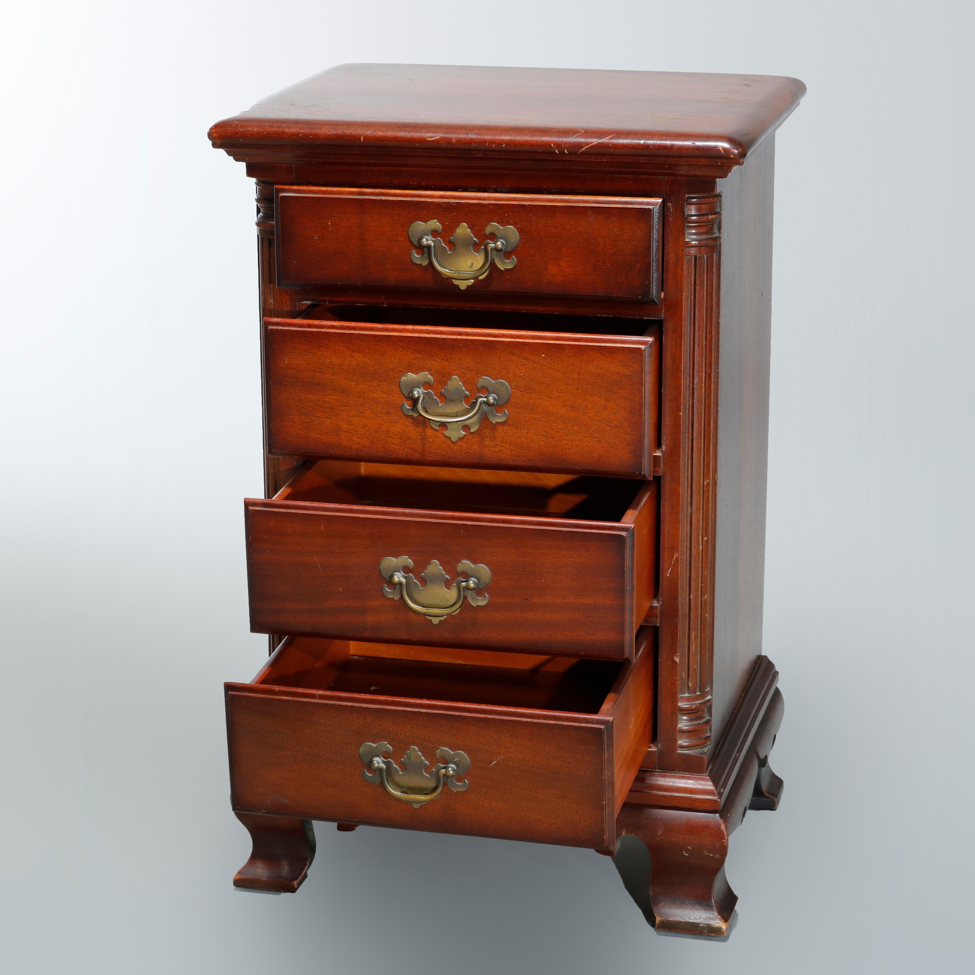 An antique Chippendale style side stand offers mahogany construction with four drawers flanked by quarter columns, brass pulls and raised on ogee bracket feet, original label as photographed, c1930

Measures: 27.75