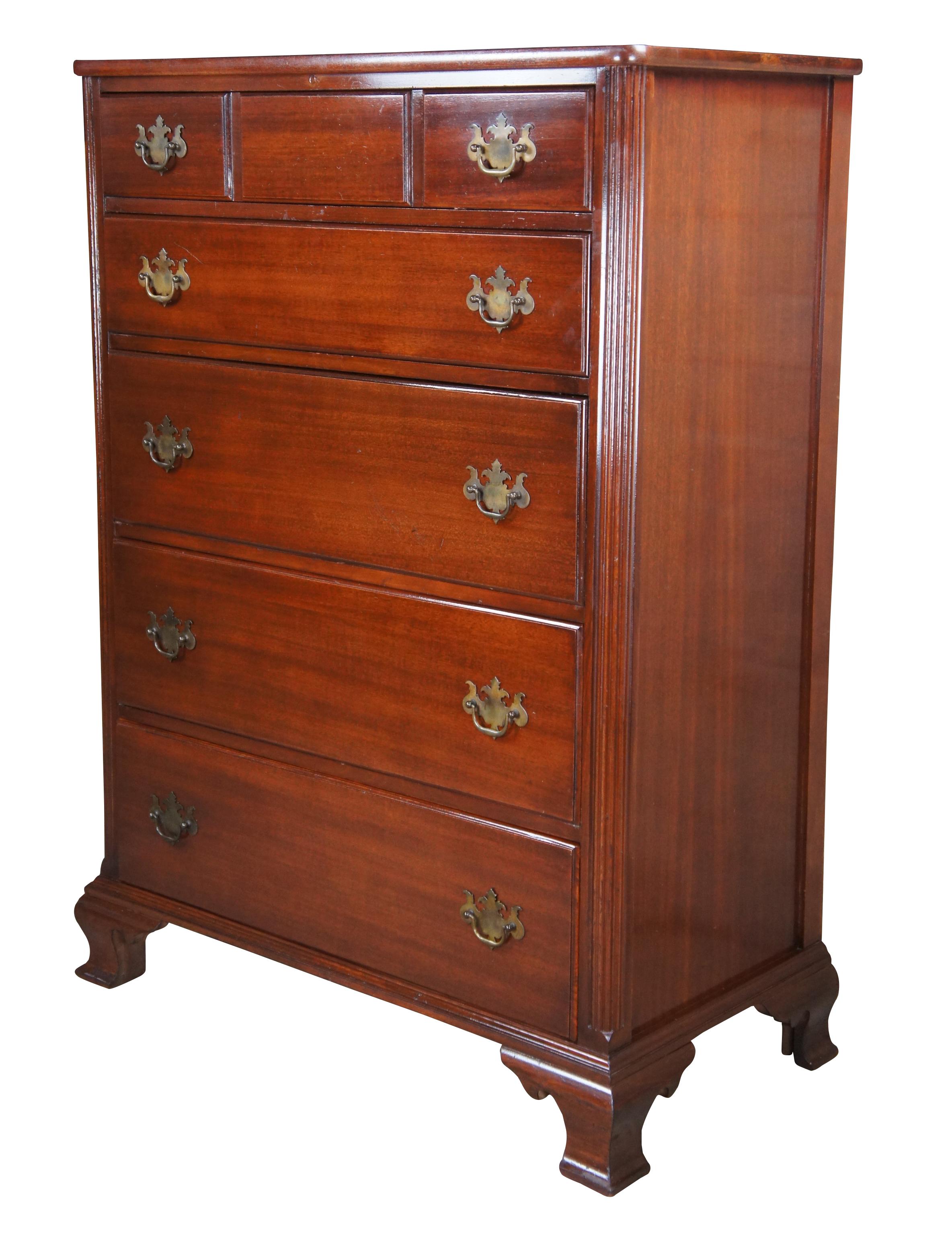 A lovely mahogany chest, circa 1940s.  Features a rectangular frame featuring 5 dovetailed drawers with Chippendale style brass bat wing drawer pulls between reeded stiles.  The case is supported by flared bracket feet.  Upper drawer is divided with