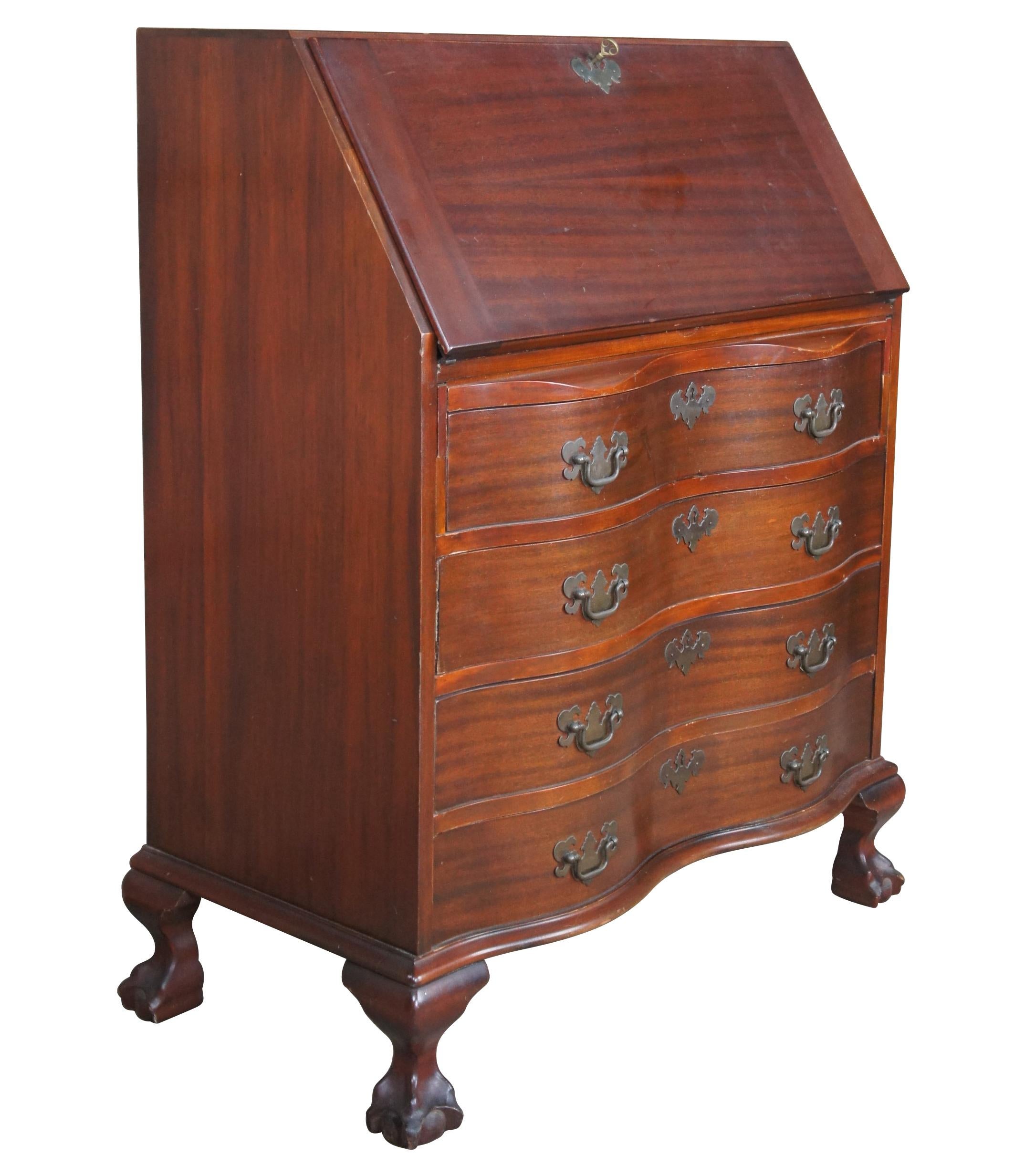 Antique Chippendale secretary or writing desk. Made of mahogany featuring serpentine form with drop front writing surface that opens to multiple drawers and cubbies, over four oxbow drawers that are mounted with Federal brass pulls, and supported by
