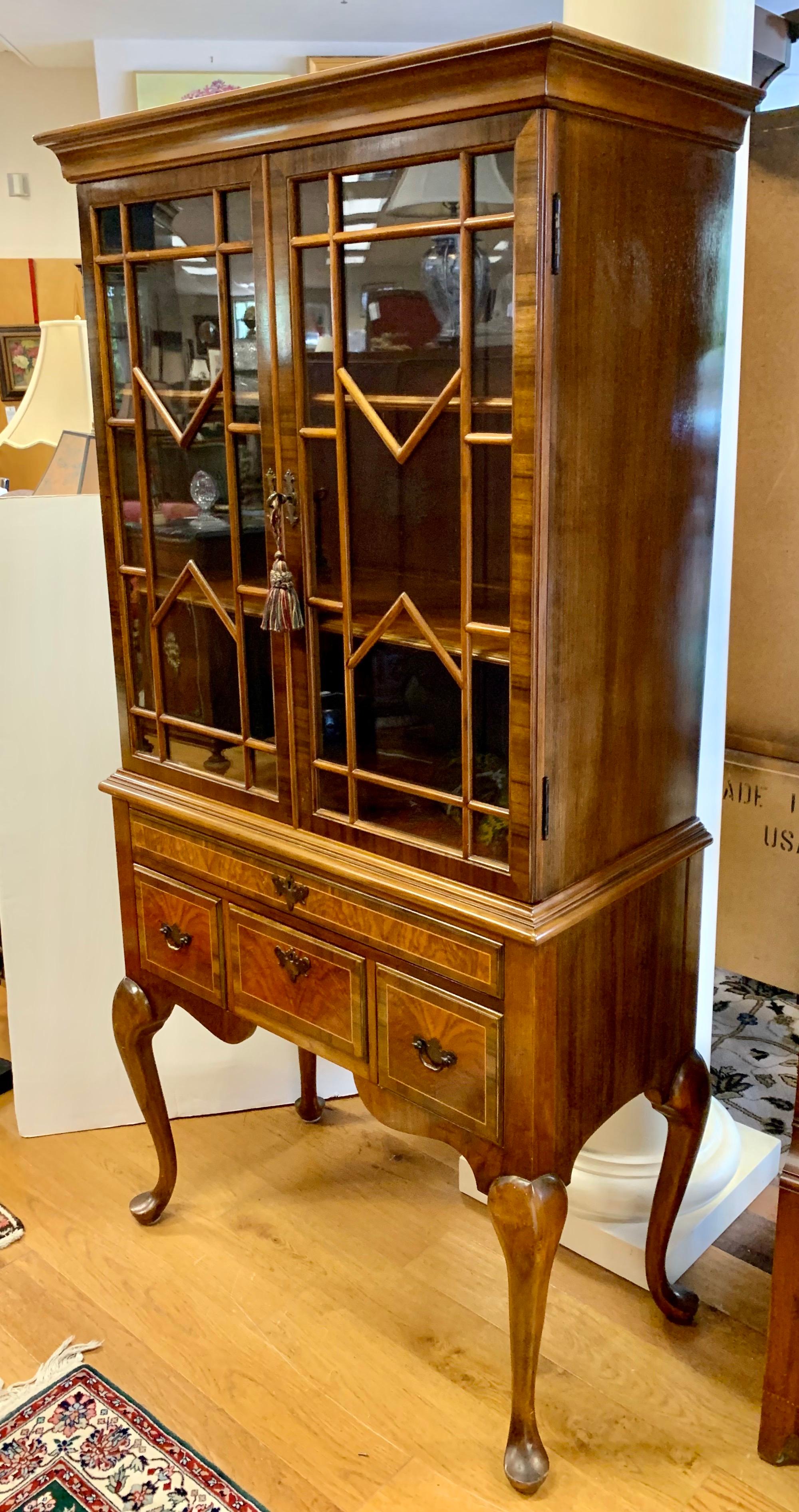 Coveted elegant Chippendale cabinet that can be used in a dining room, den, living room or library.
The finest mahogany and glass. Two piece construction. Nothing short of gorgeous.
  