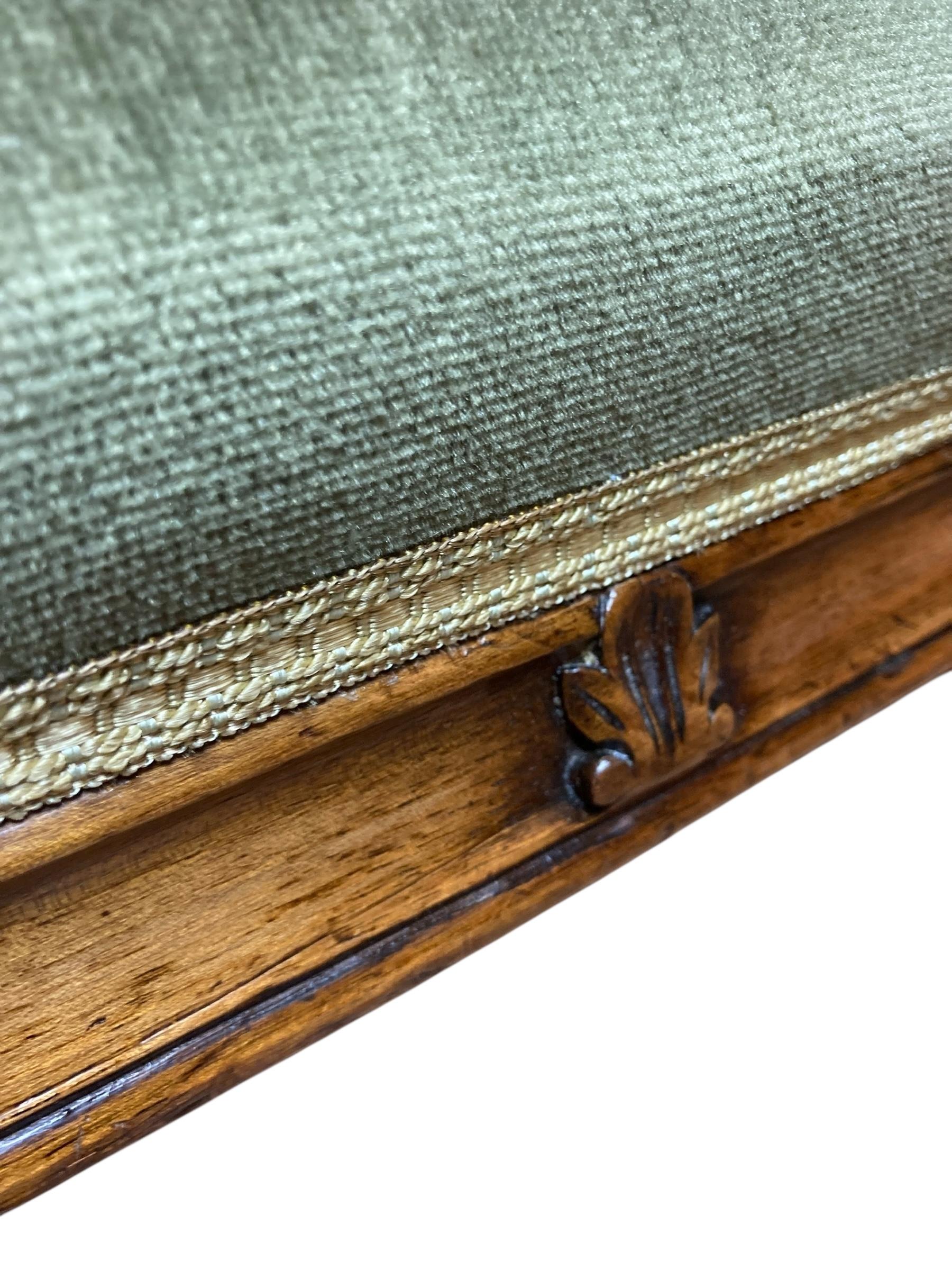 Antiker Mahagoni-Coaching- oder Kaminhocker aus der frühen viktorianischen Zeit, um 1840. Ein schöner Hocker mit niedrigem, breitem Profil. Der Rahmen aus Mahagoniholz zeigt feine Maserungen und geschnitzte Details. Hochwertige olivgrüne