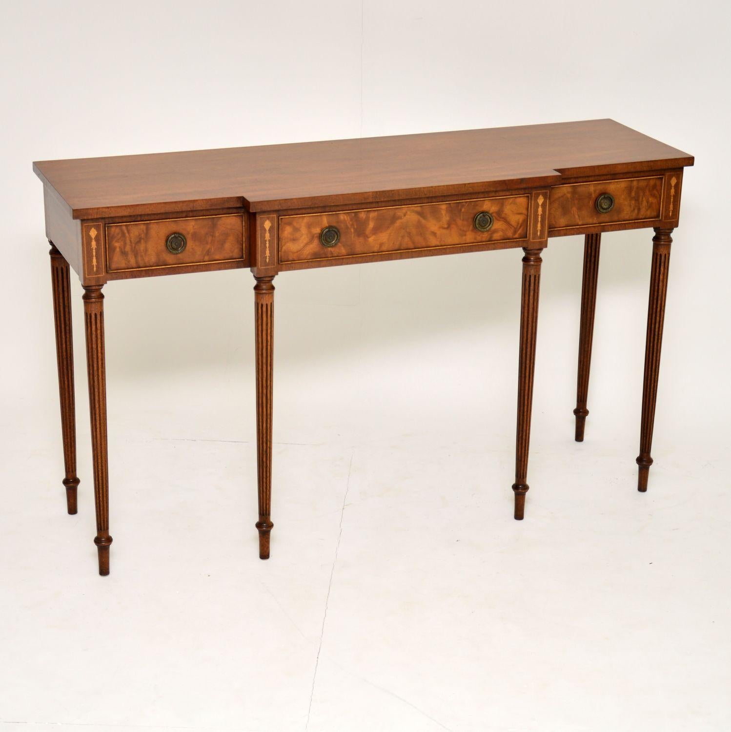 Very elegant antique Sheraton style mahogany breakfront console side table which is both long & slim. It’s Fine quality & in excellent condition. There are three flame mahogany drawers with original brass handles & Fine dovetails. There are also