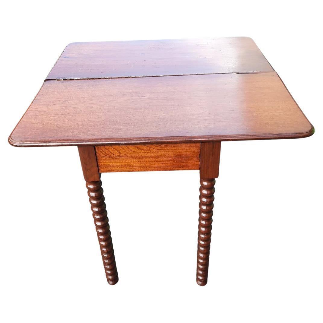 Beautiful solid mahogany console table from the 1930s. Flip top open to reveal a square 34 inches top that can be used as game table or small dining table. Very steady and beautiful bobbin legs work. Under table storage space. Table appears to have