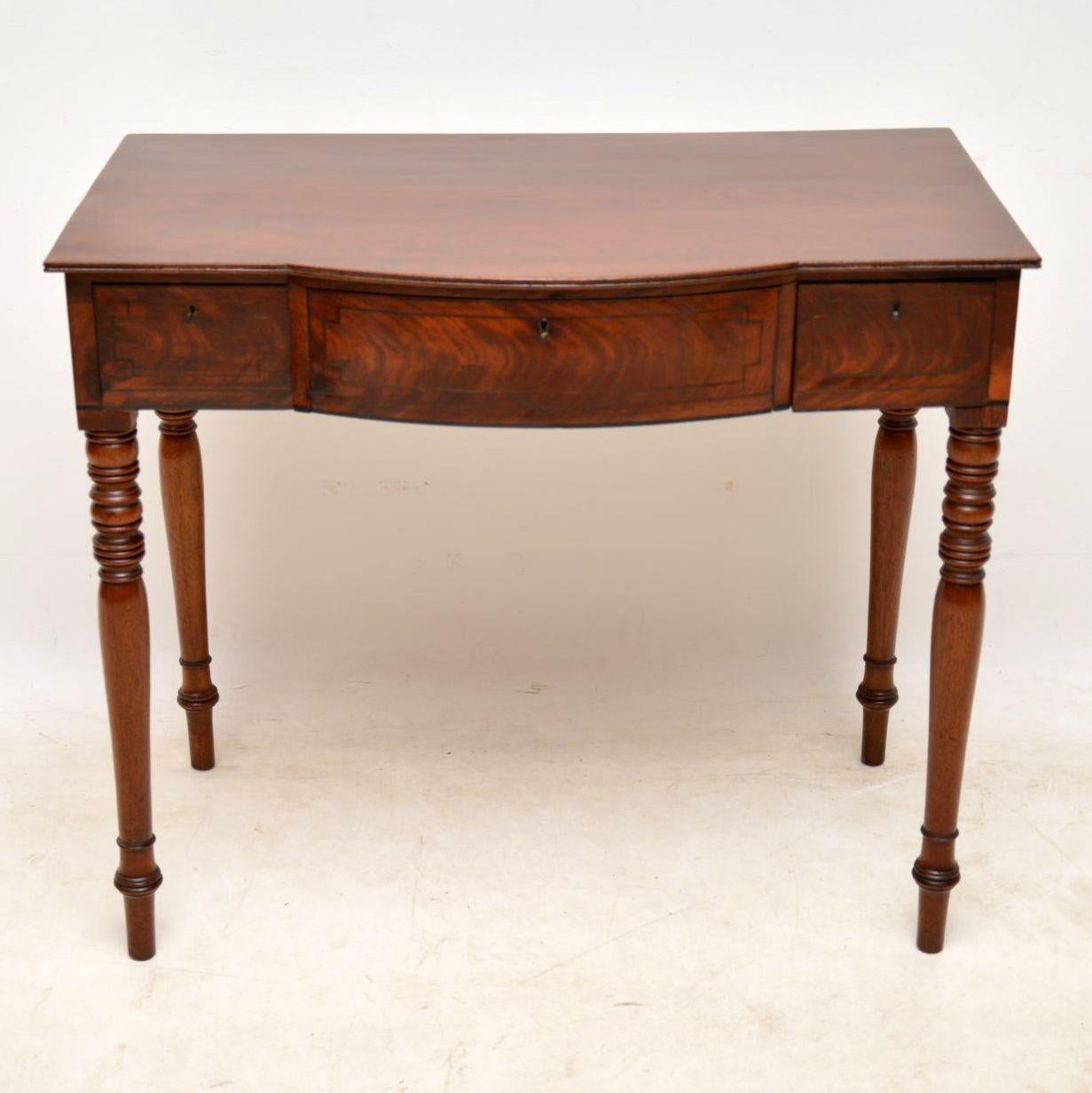 Antique mahogany table in good condition and with a lovely original colour, full of character. I would date this table to around the 1820s-1840s period. It has a solid mahogany top with a lovely grain, flame mahogany drawers with fine dovetails,