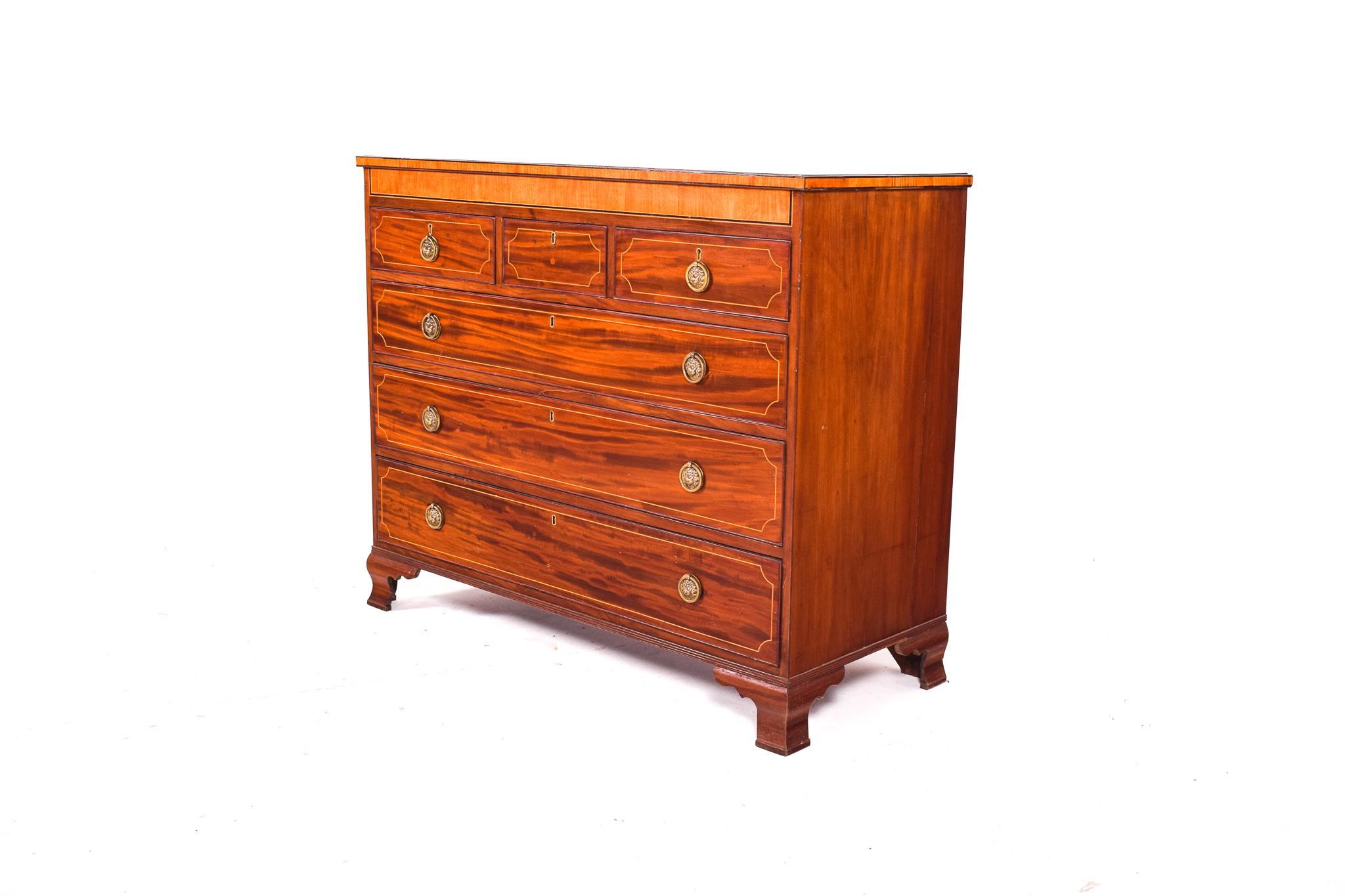 This D. Maria style chest features six drawers. The drawer fronts have flame/crotch mahogany veneers, with stringing and crossbanded mahogany borders. The hardware is of the period, and the correct style for the piece in yellow metal.