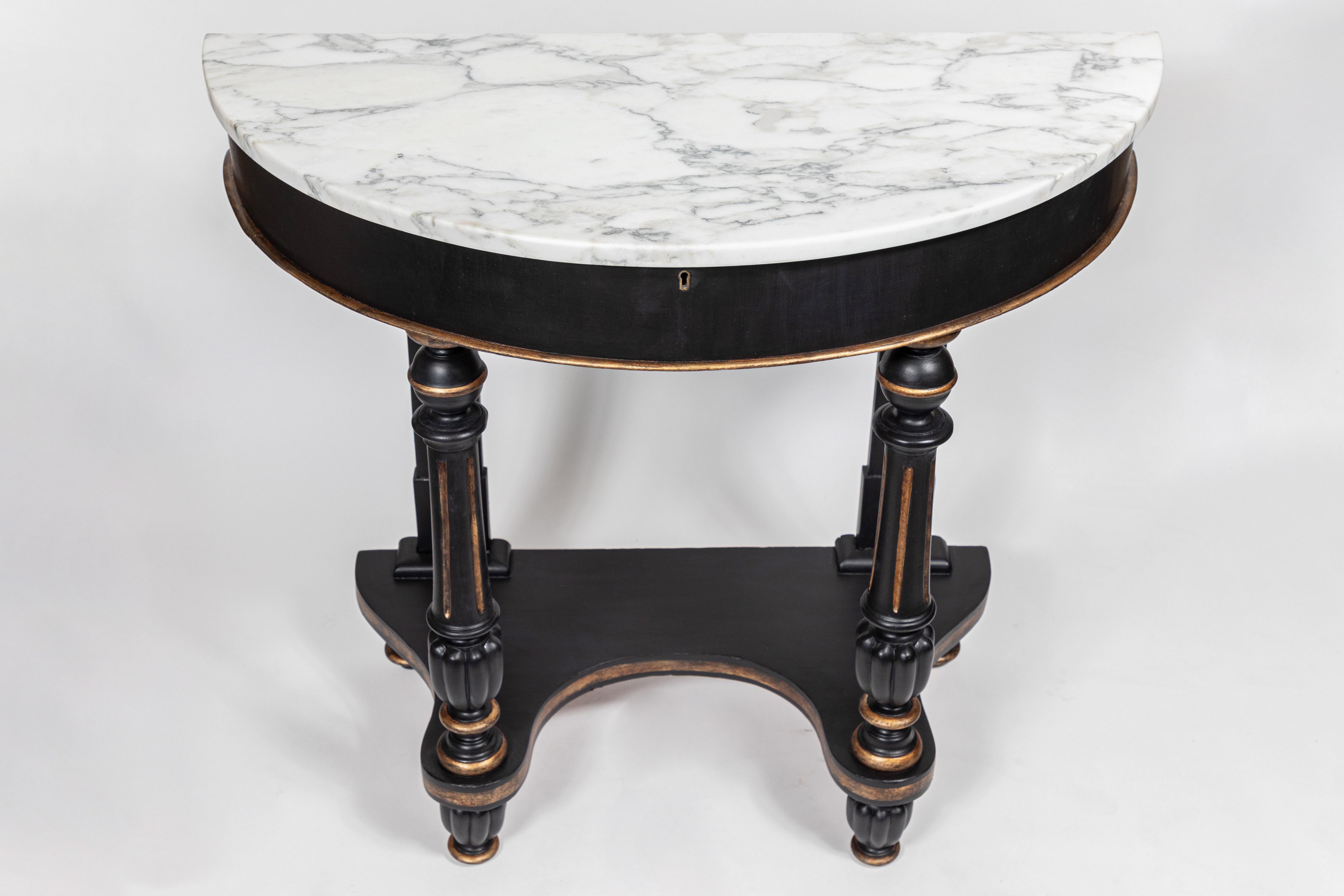 Antique Mahogany demilune table with William and Mary style turned legs.

Featuring a new matte black hand painted finish with antique gold accents with a new Carrara marble top.
