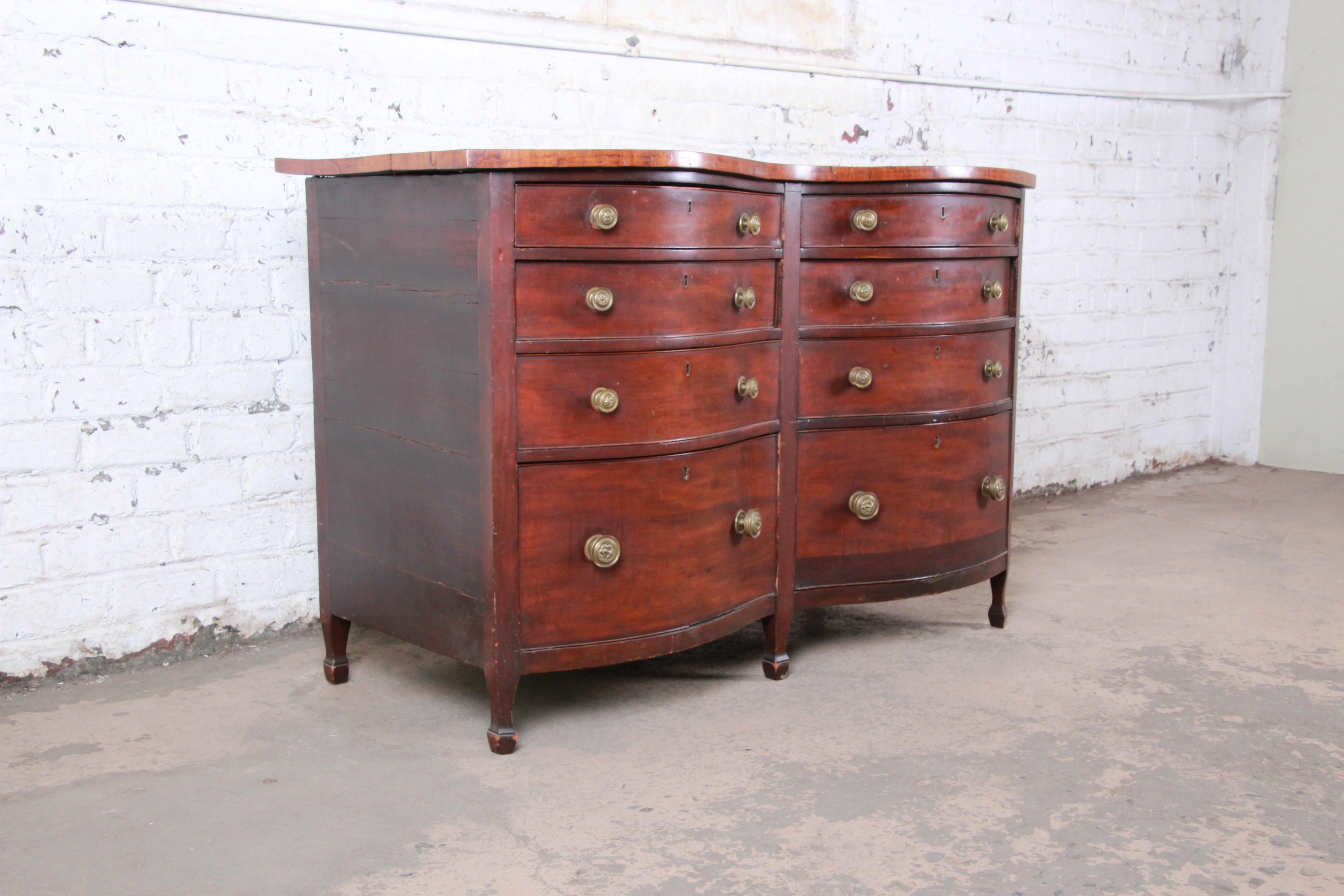 A gorgeous antique mahogany double bow front eight-drawer dresser

USA, 19th century

Mahogany and brass lion face hardware

Measures: 56.25