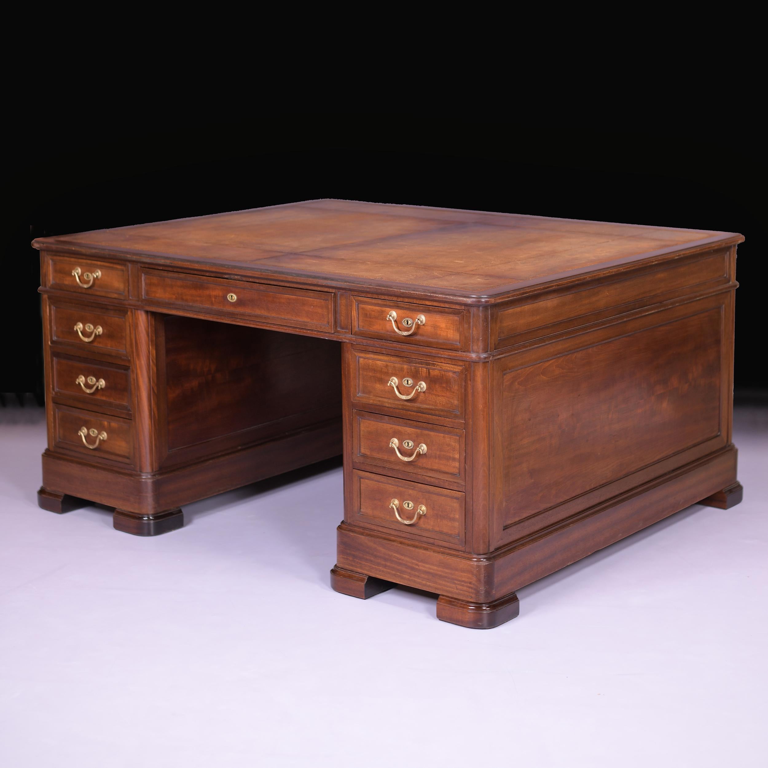 A very fine and imposing antique mahogany double sided partners desk of large proportions, the rectangular top features a stunning brown and gold tooled leather writing surface. This desk is the same on each side. Each side is fitted with three