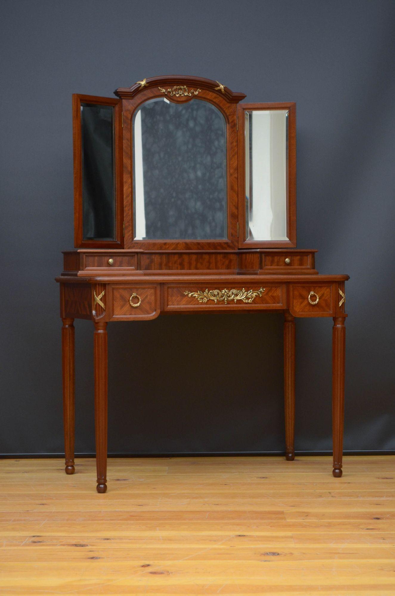 Sn5386 An elegant French dressing table in mahogany having shaped triple mirror with original bevelled edge glass (minor imperfections) decorated with a ormolu bows to the top above small drawers and parquetry design top with moulded edge and long