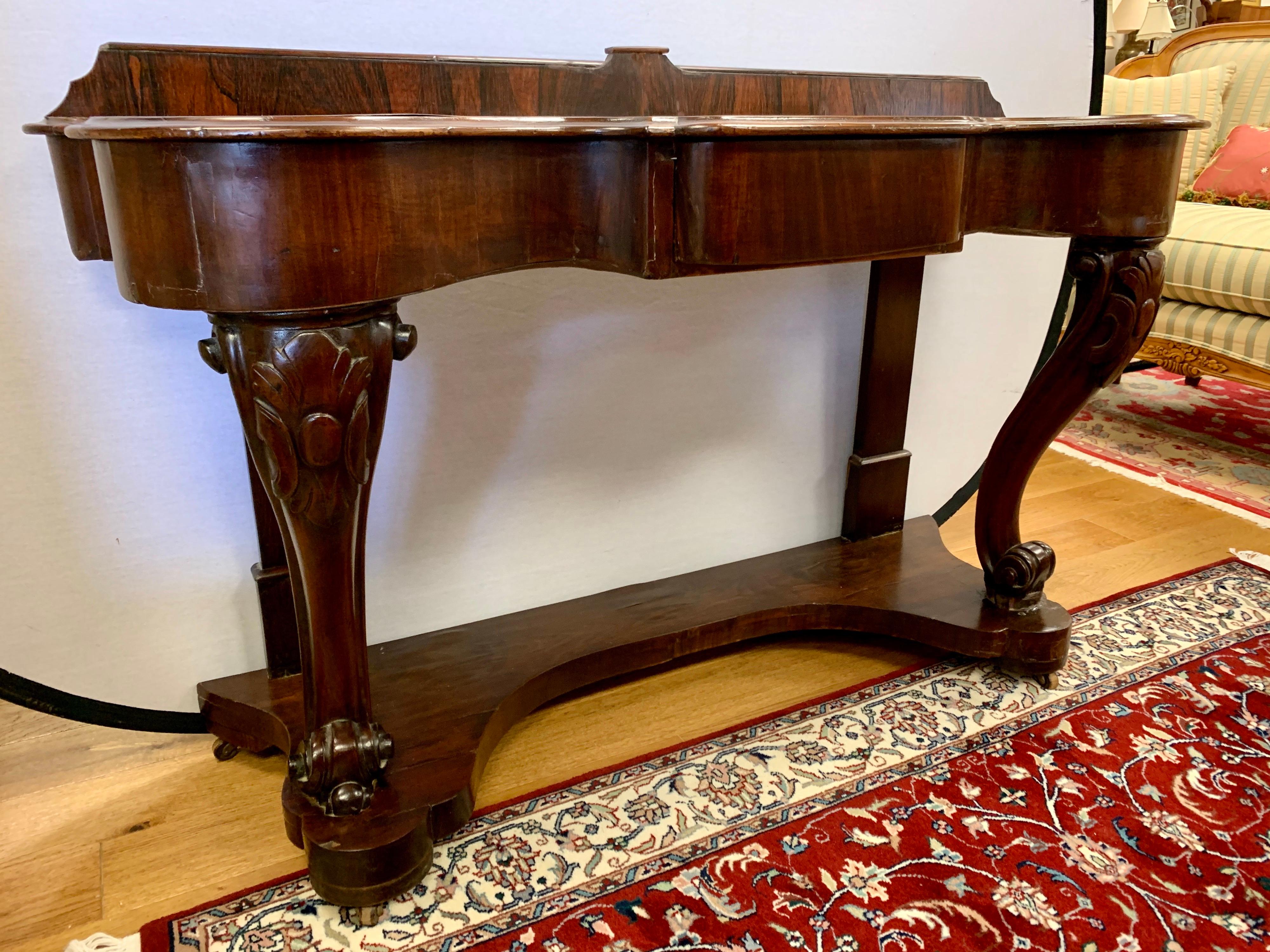 Elegant 19th century Empire console table with rear border which measures 33.5 from top to bottom, circa mid-19th century. Age appropriate wear. Features one center drawer and caster wheels for ease of movement. Features a beautiful aged patina.