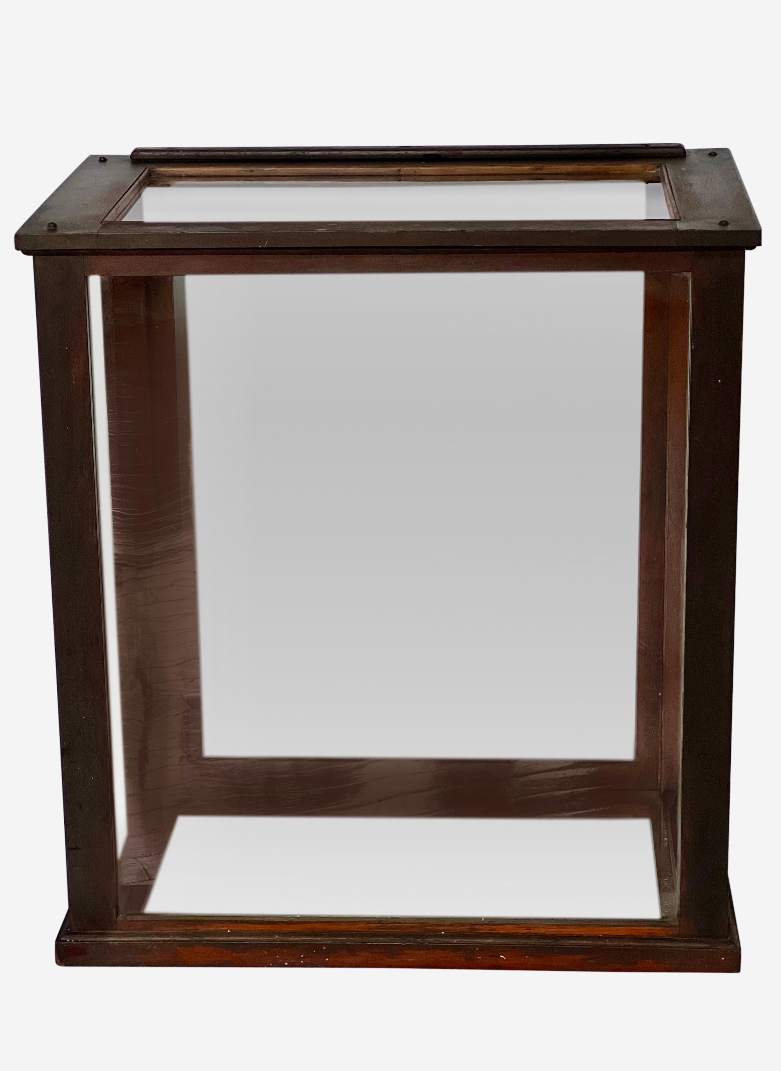 Antique mahogany tabletop display case, England, circa 1900.

This wonderful six-sided glass vitrine features a vertical sliding panel in the back. All original glass and mahogany wood frame are in good condition. Simple design with the old glass