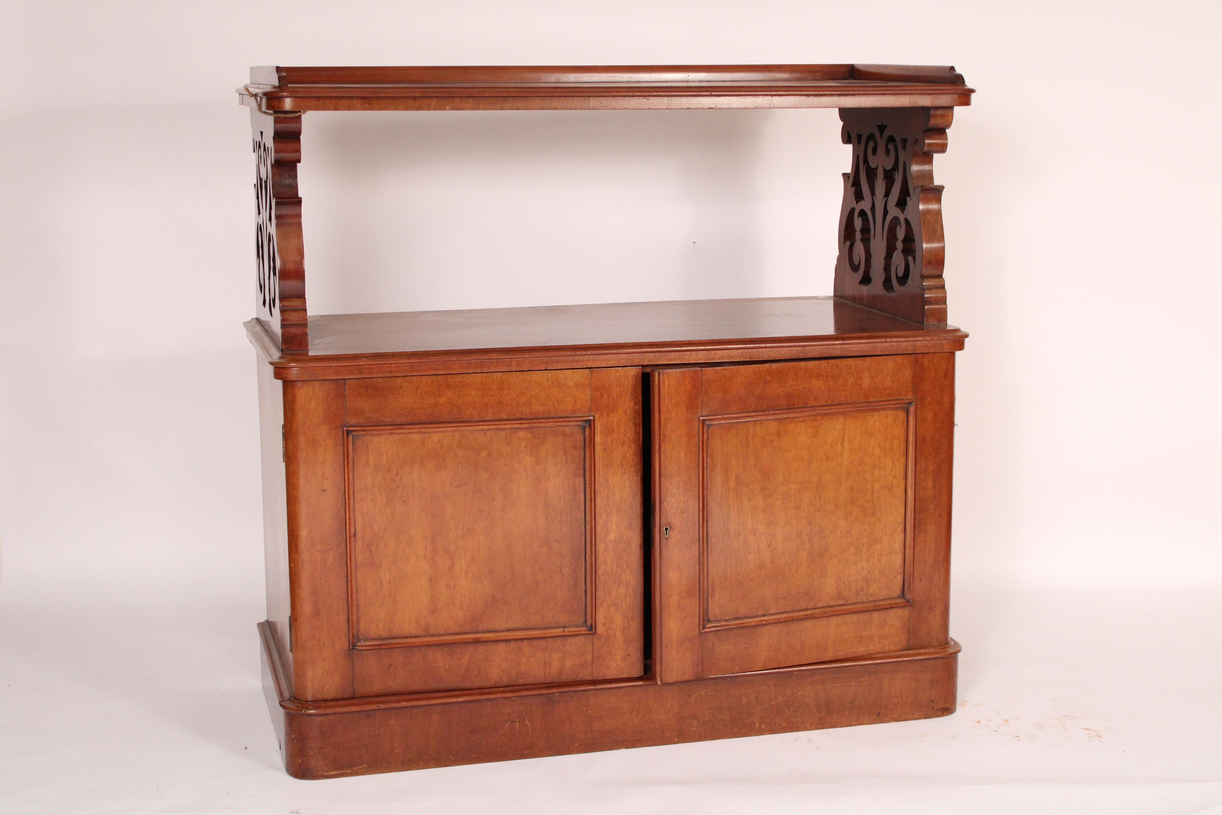Antique English mahogany etagere / cabinet, late 19th century. With a rectangular top with rounded front corners and a gallery top, a reticulated mahogany support supporting the top, the lower section with two doors, inside of doors are drawers on
