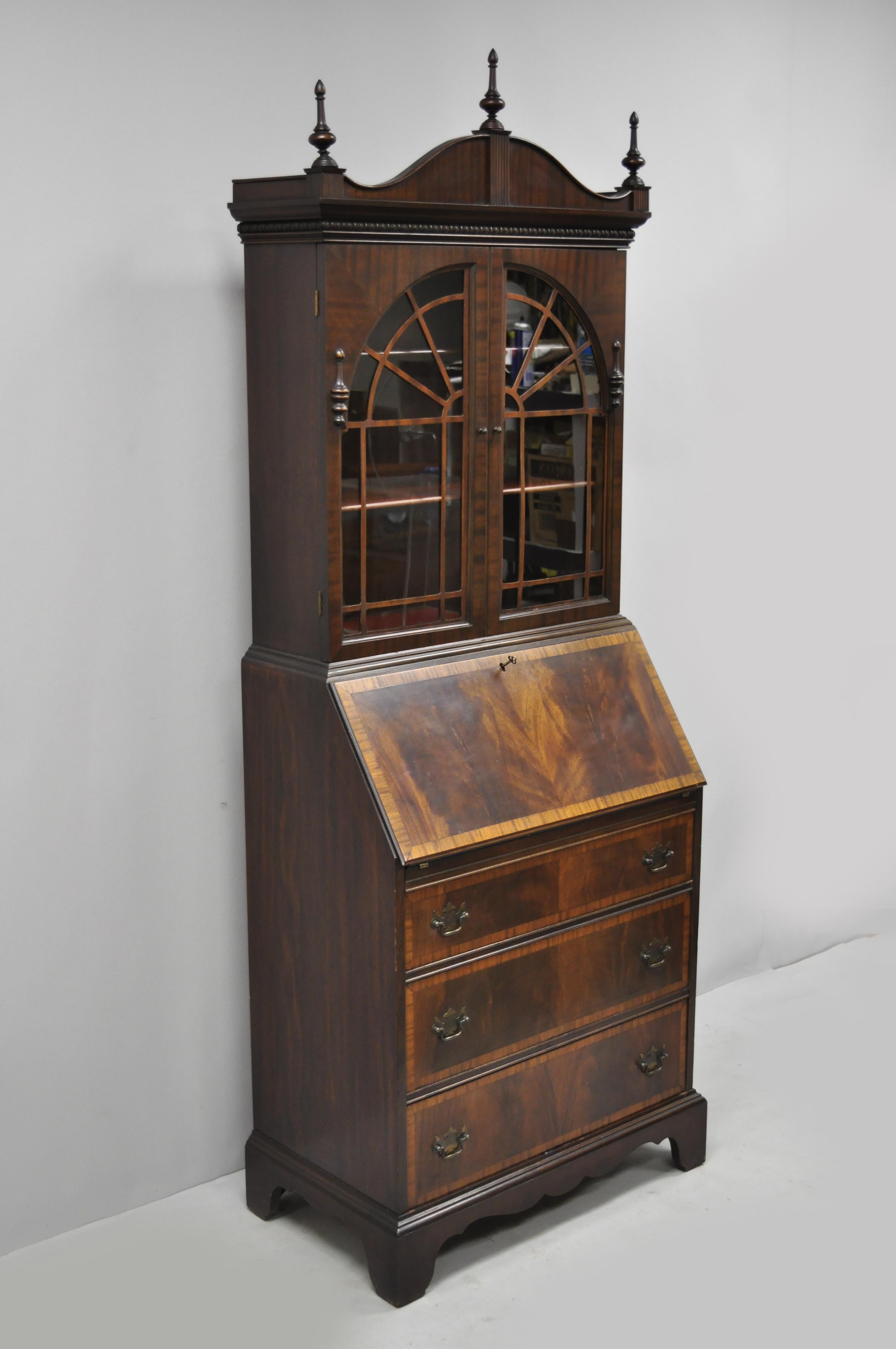 Antique mahogany Federal Chippendale style secretary desk with banded front. Item features banded front, beautiful wood grain, 2 swing doors, working lock and key, 3 dovetailed drawers, 2 wooden shelves, quality American craftsmanship, circa early