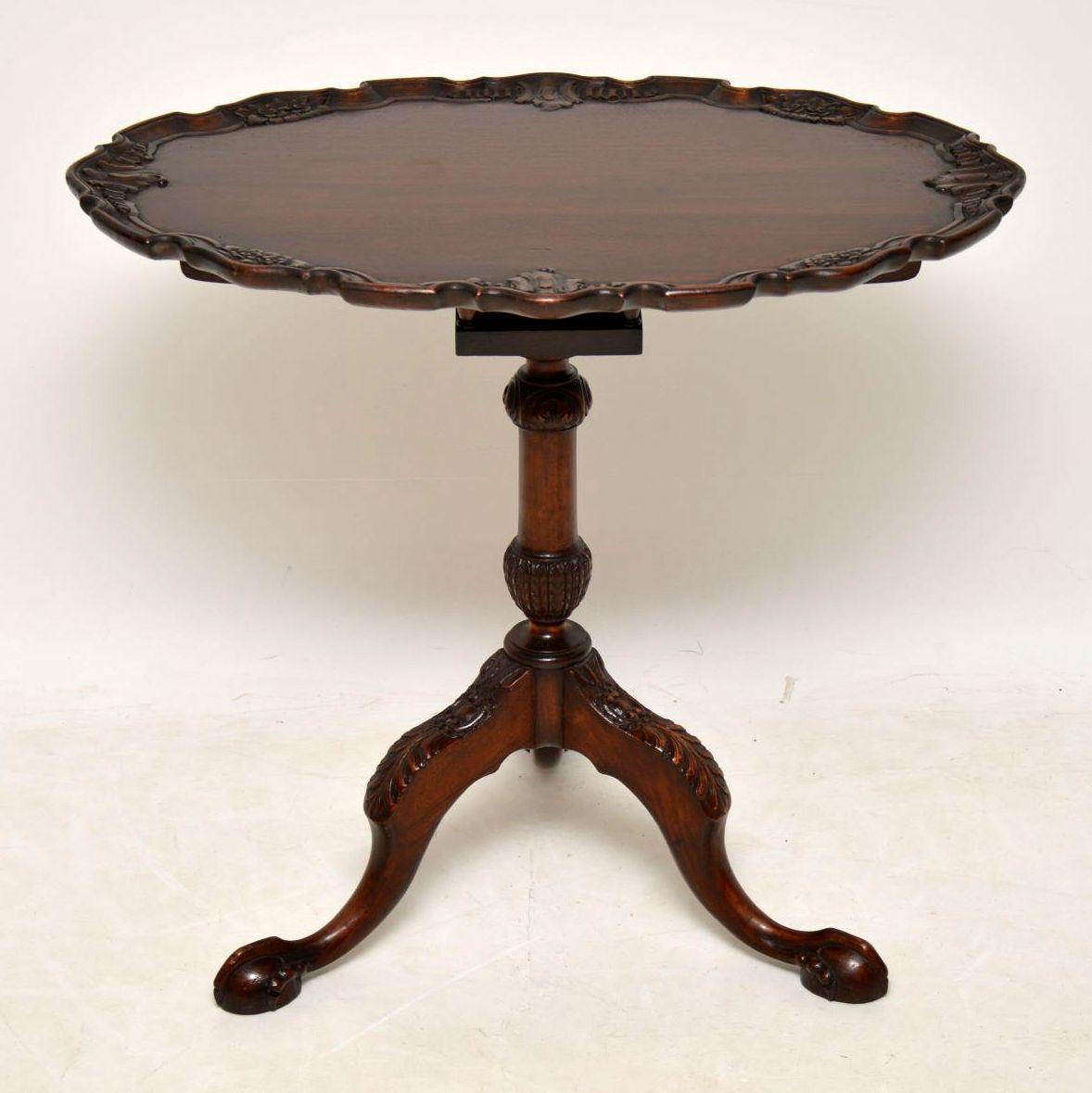 Antique Chippendale style solid mahogany flip top occasional table in good condition and dating from circa 1930s-1950s period. At first sight it actually looks Georgian period, because of the quality of the carvings. This table has an oval top with