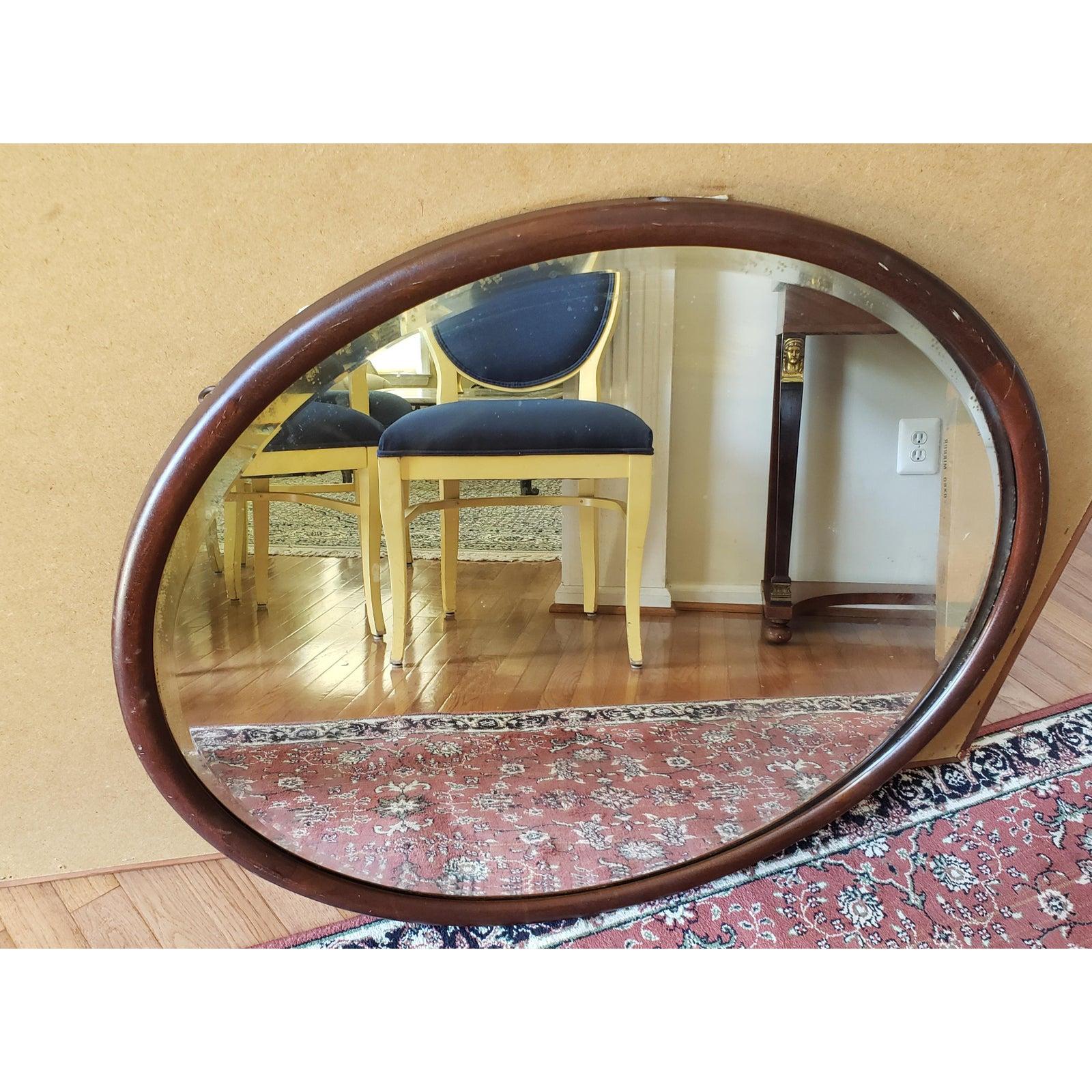 Early 1900s mahogany frame Wall mirror. Oval shape. Measures 36 inches in width x 31 inches in height.
     