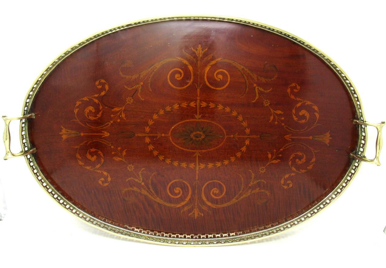 Superb Late Victorian Antique mahogany twin handled Inlaid serving drinks Tray of oval outline and of outstanding quality, of English origin, last quarter of the Nineteenth Century. 

The main area incorporating profuse Walnut, Satinwood and