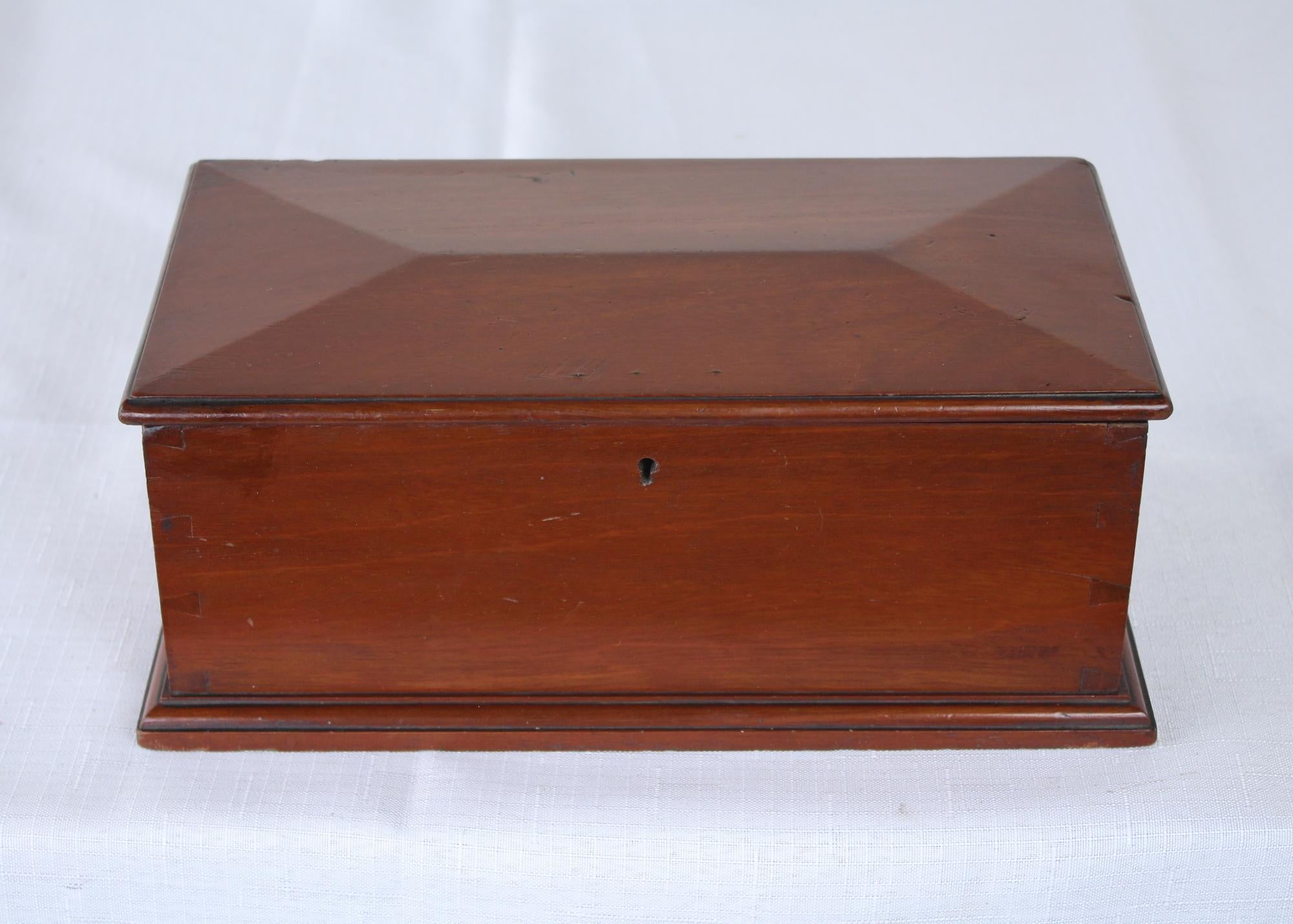 A simple mahogany box with a lovely shaped top. Very simple with good mouldings at the base and visible dovetailing. Highly decorative.